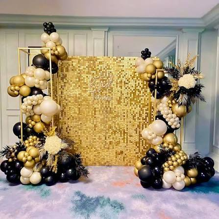 Gold shimmer wall with black and gold balloons