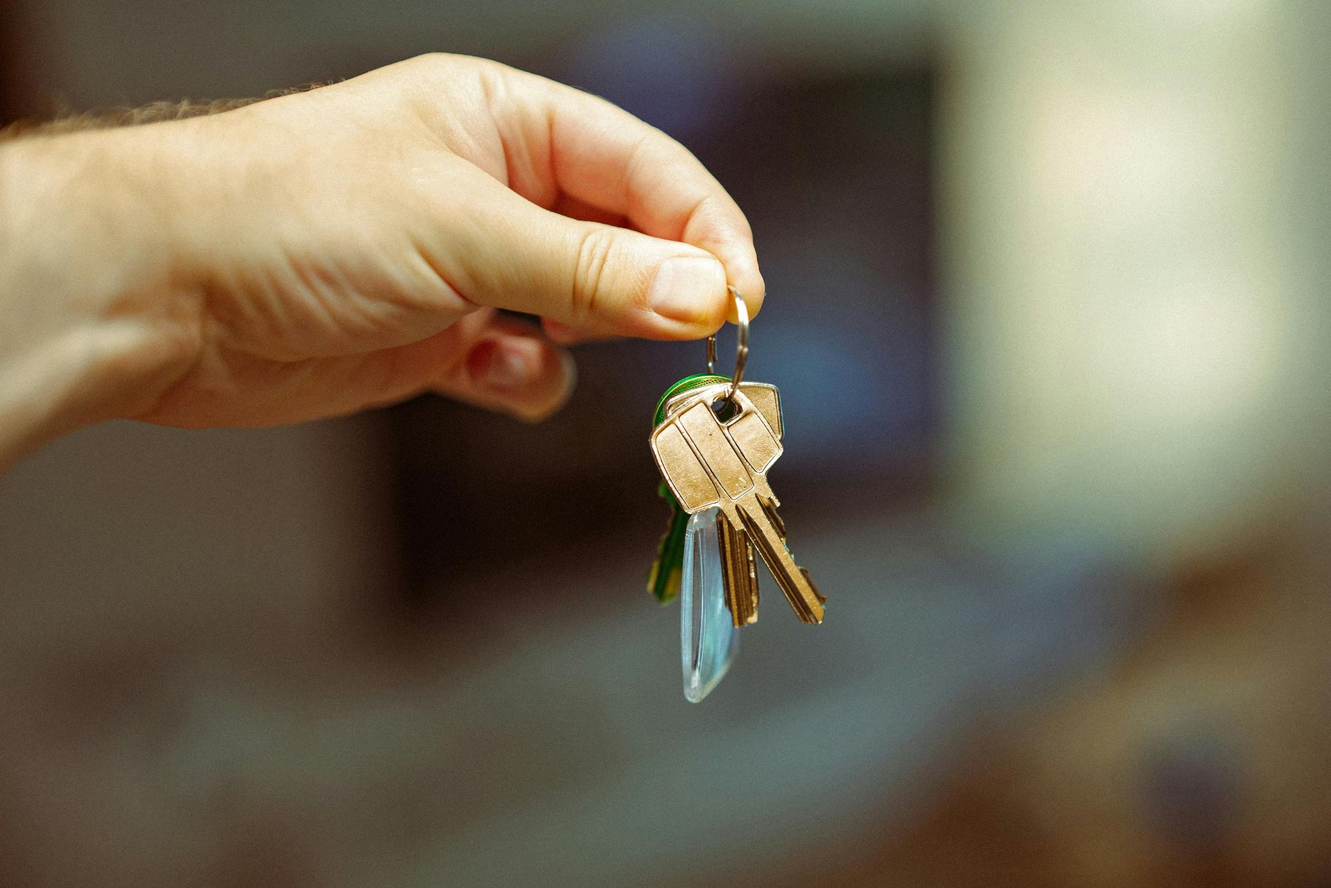 A person is holding a bunch of keys in their hand.