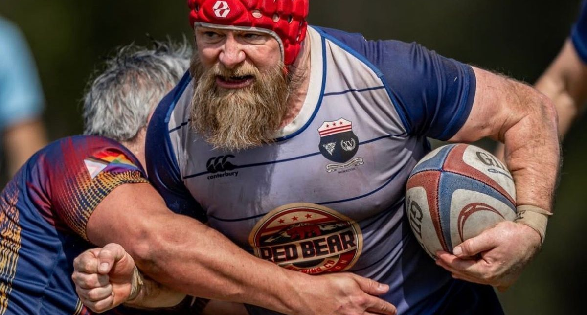 Renegades player in a blue and red jersey holding a rugby ball during a match