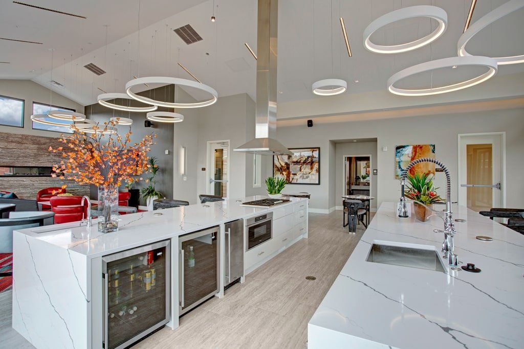 A large kitchen with white counter tops and stainless steel appliances at Woodin Creek Village.