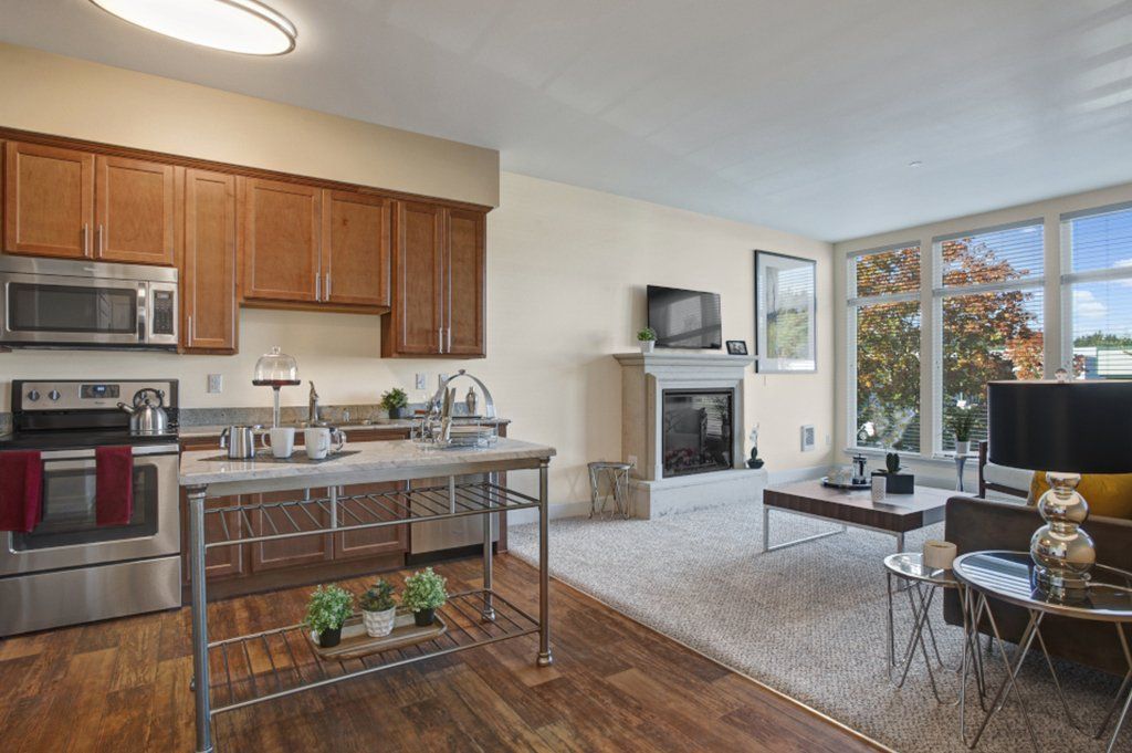 A kitchen with stainless steel appliances and wooden cabinets