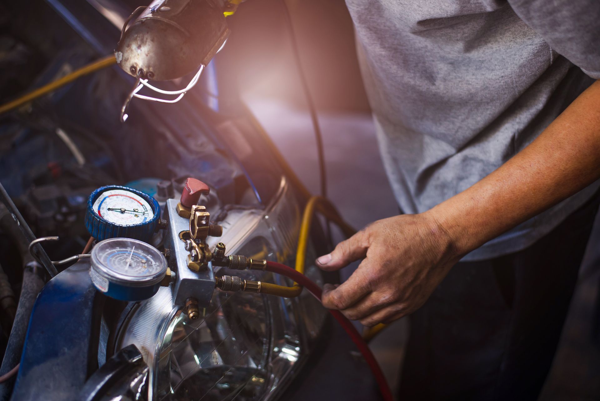 A man is working on a car in a garage.