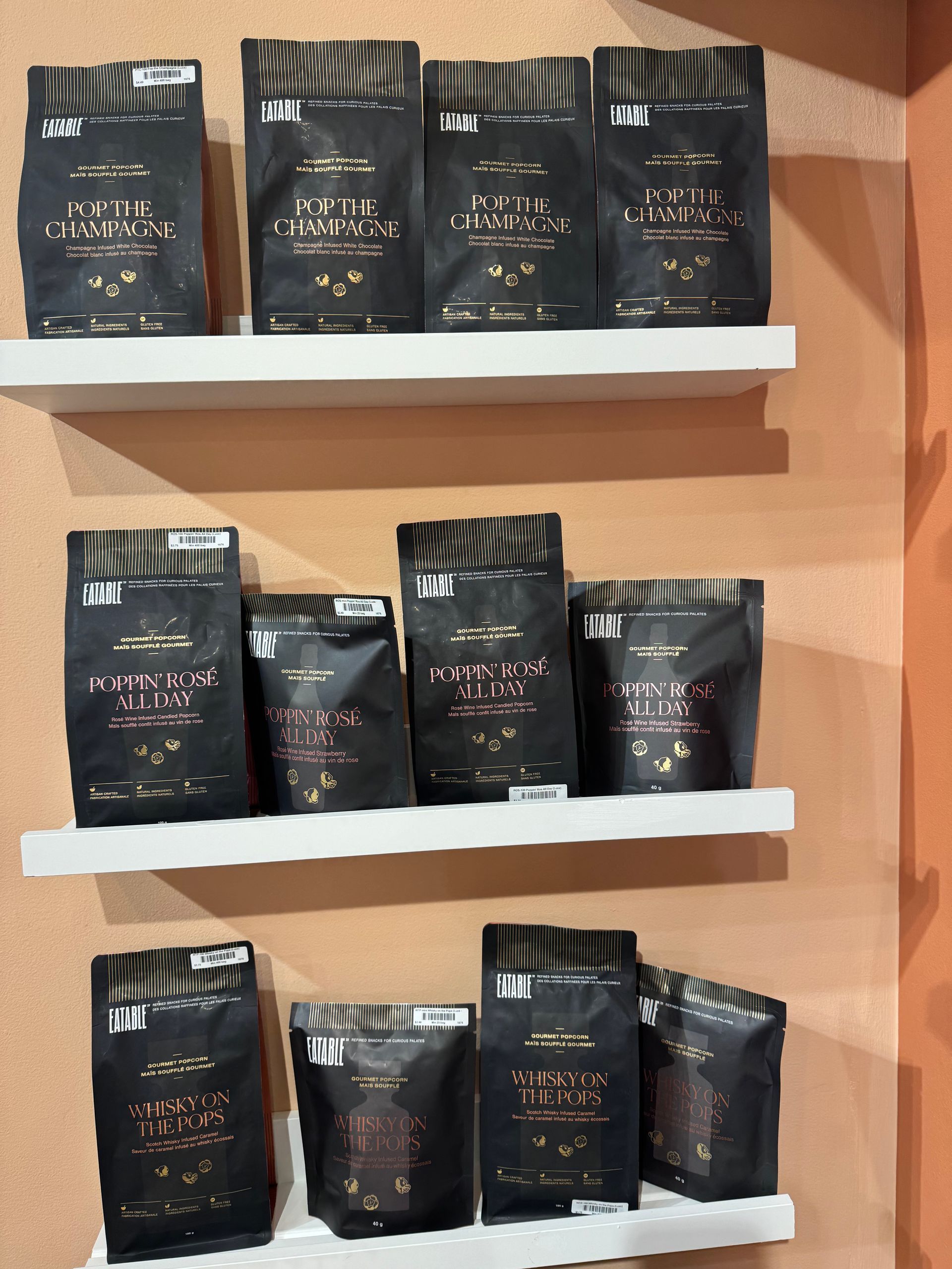 A row of shelves filled with bags of coffee including one that says ' a ' on it