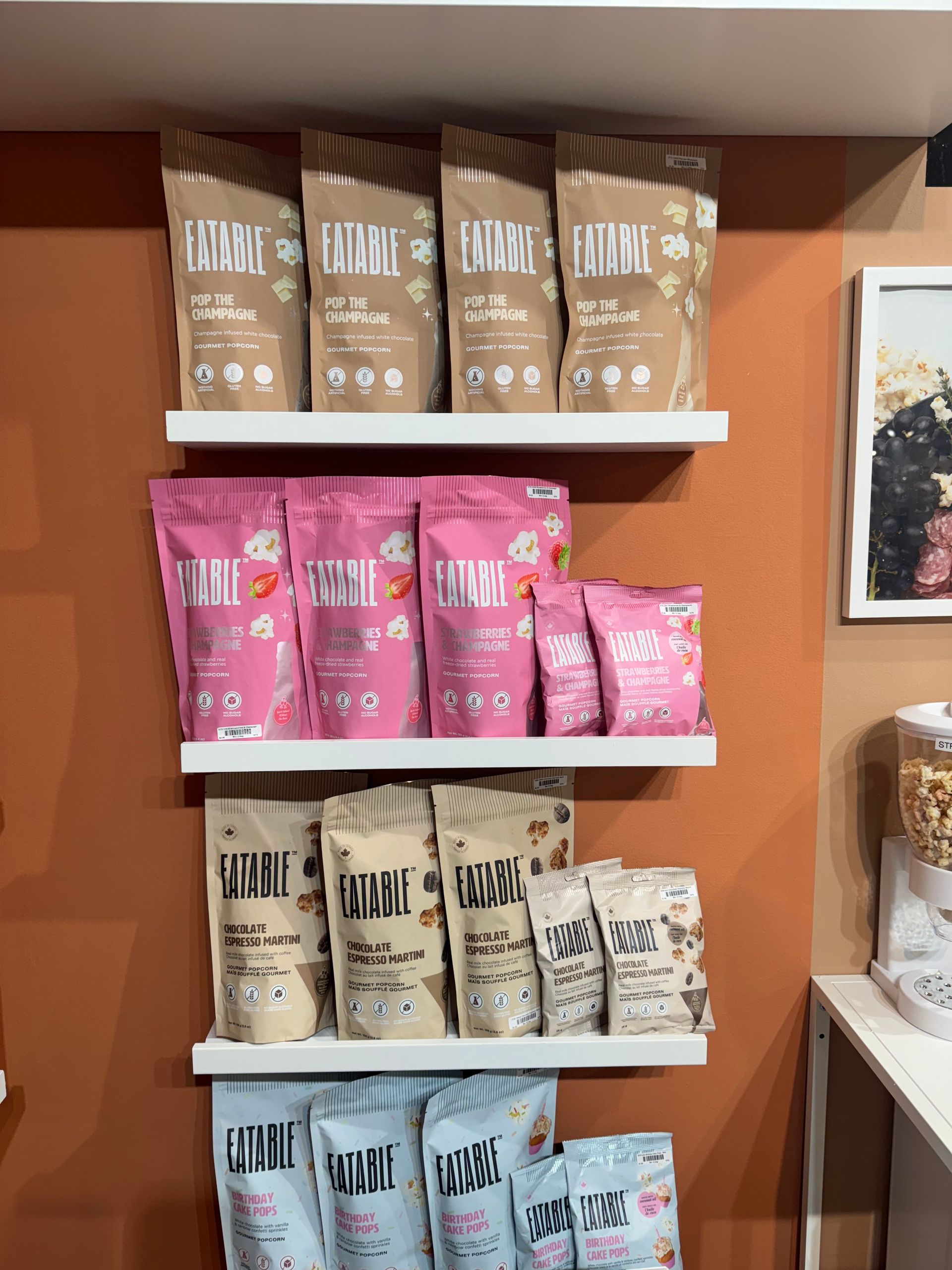 A shelf full of snacks including a bag that says ' i am ' on it
