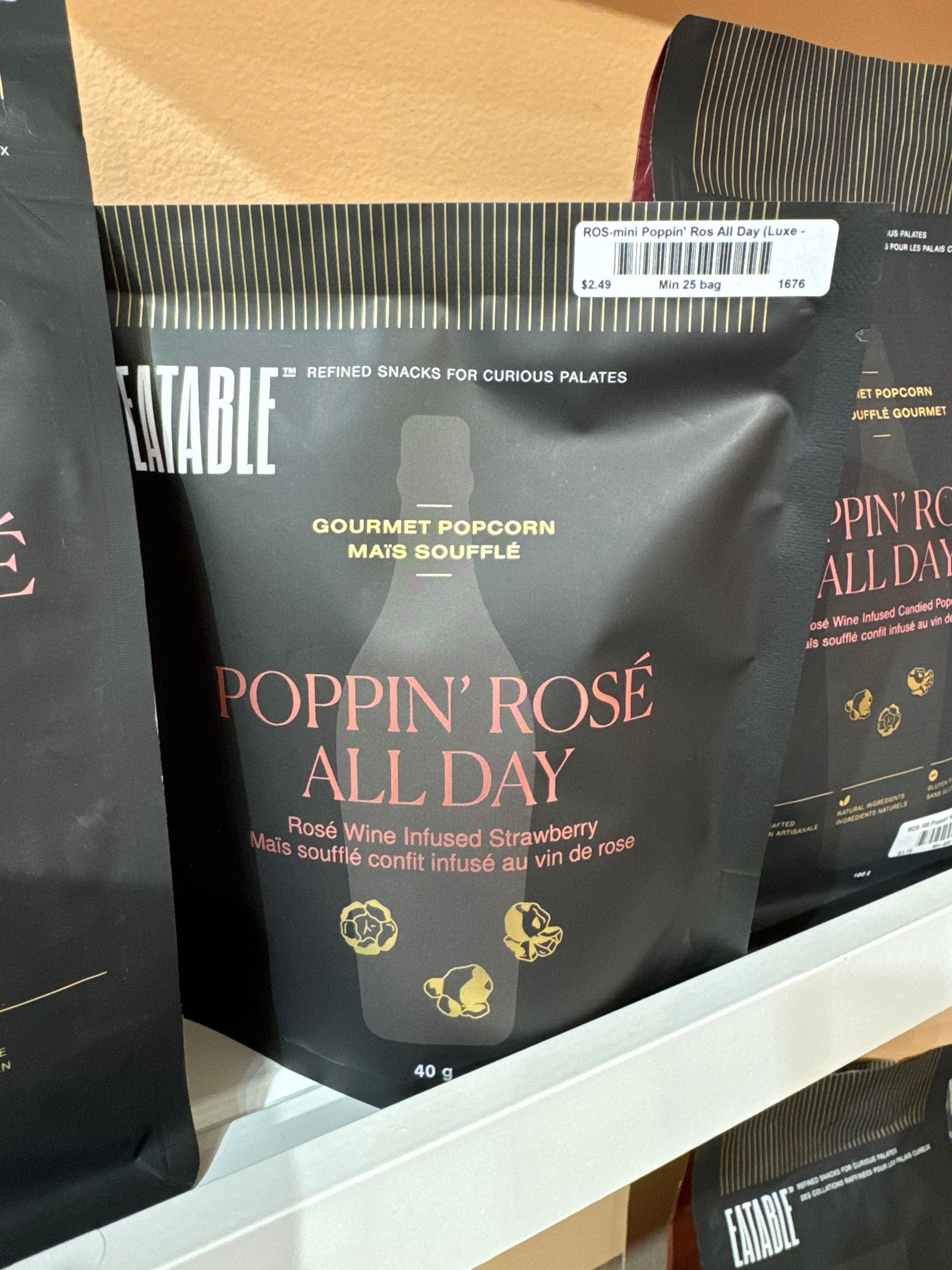 A bag of poppin ' rose all day popcorn sits on a shelf