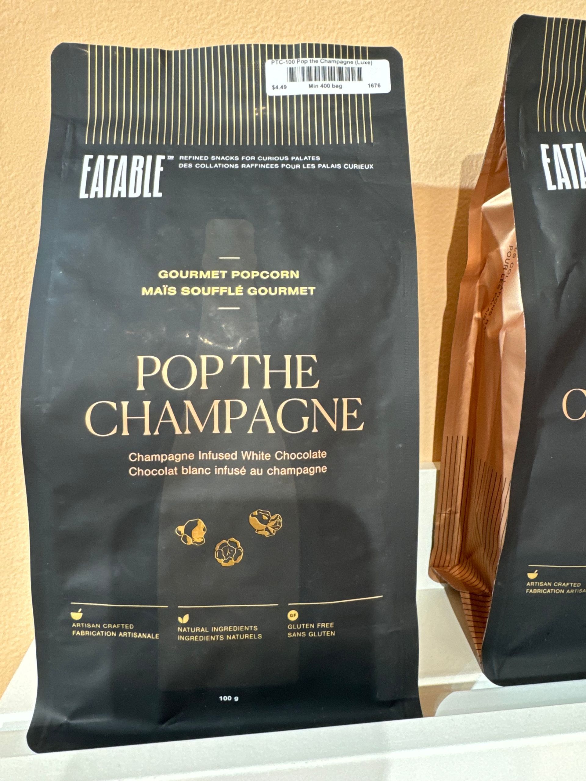 Two bags of pop the champagne sit on a table