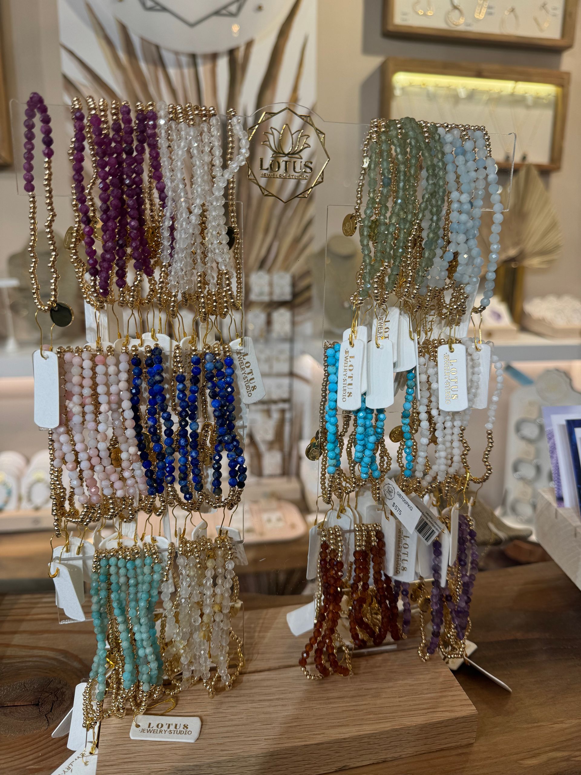 A display of bracelets and earrings on a wooden table