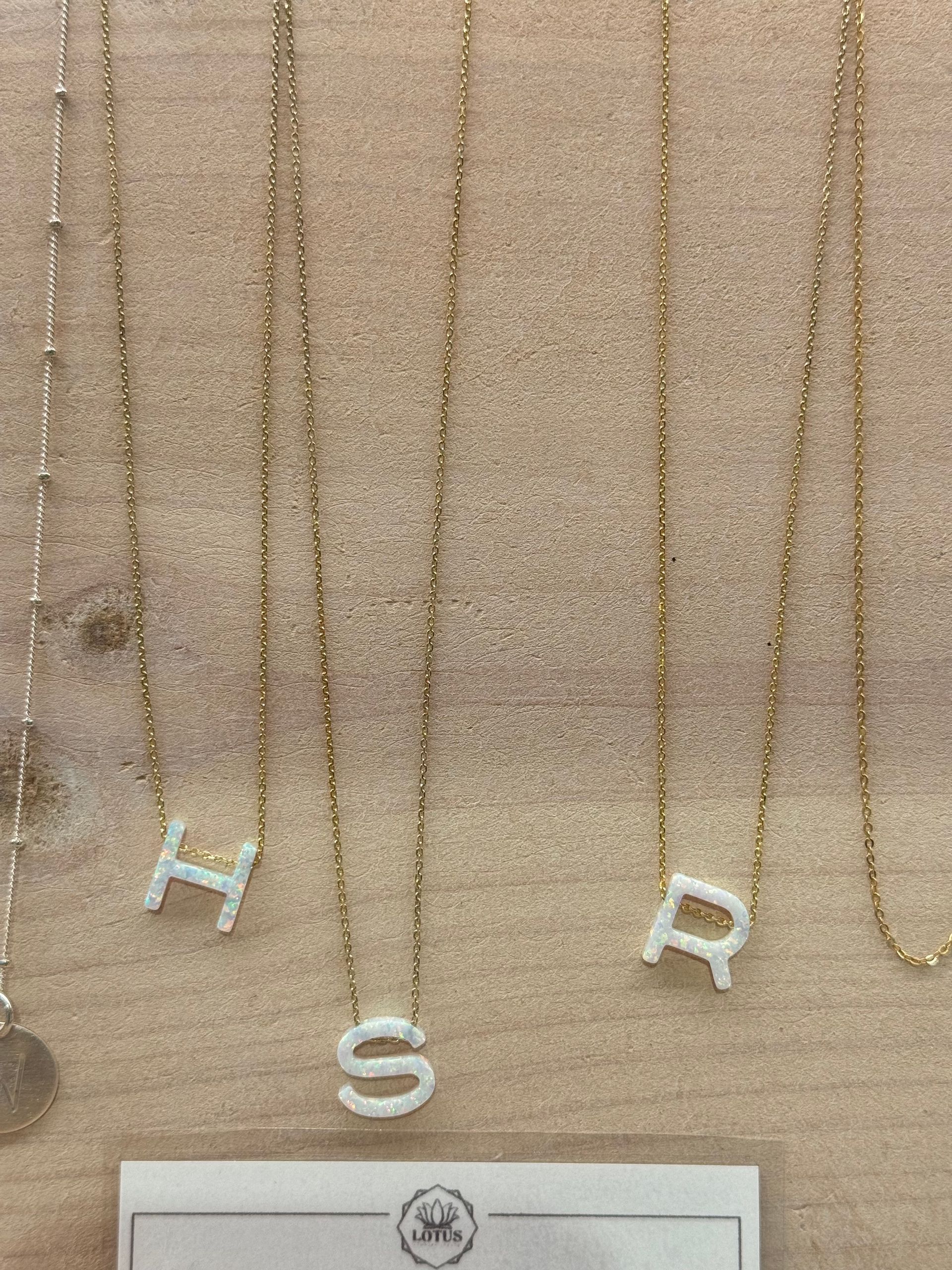 A necklace with the letter h on it