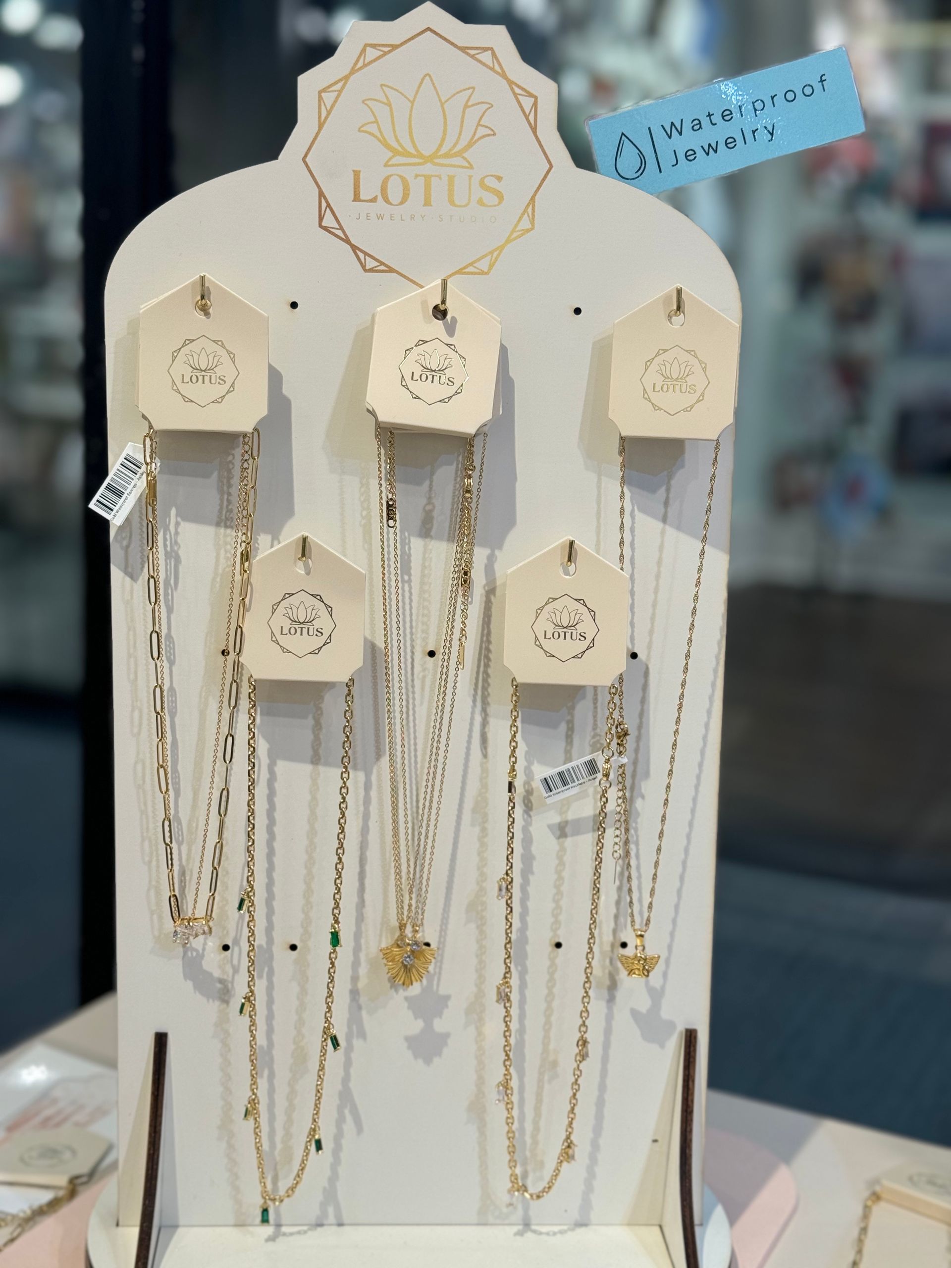 A display of lotus necklaces on a table
