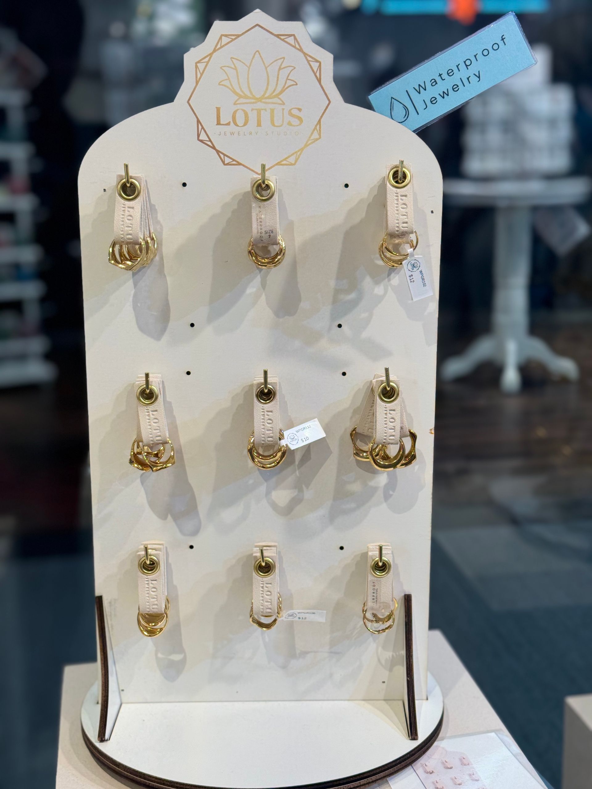 A display of lotus earrings is sitting on a table