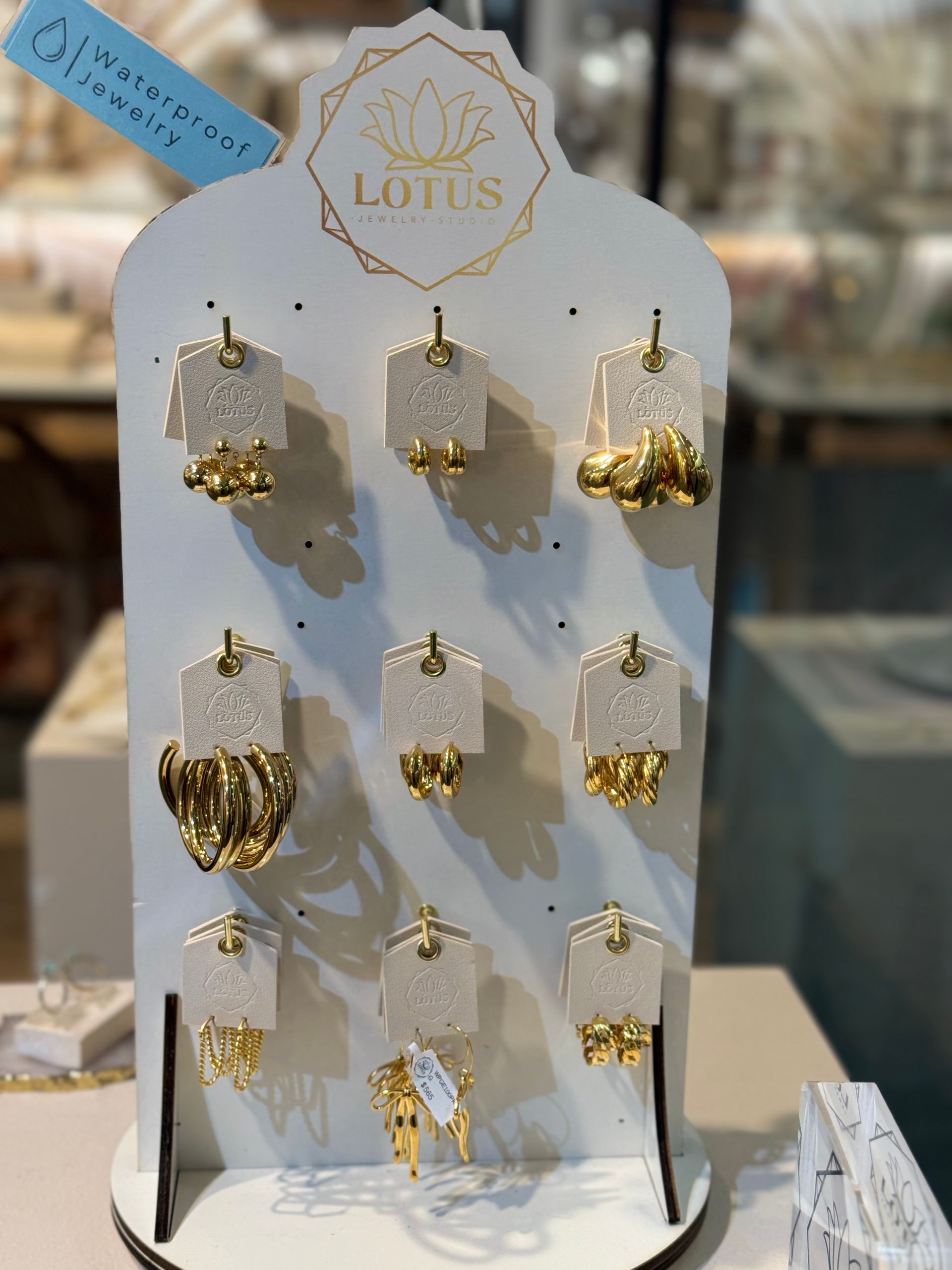 A display of lotus earrings is on a table