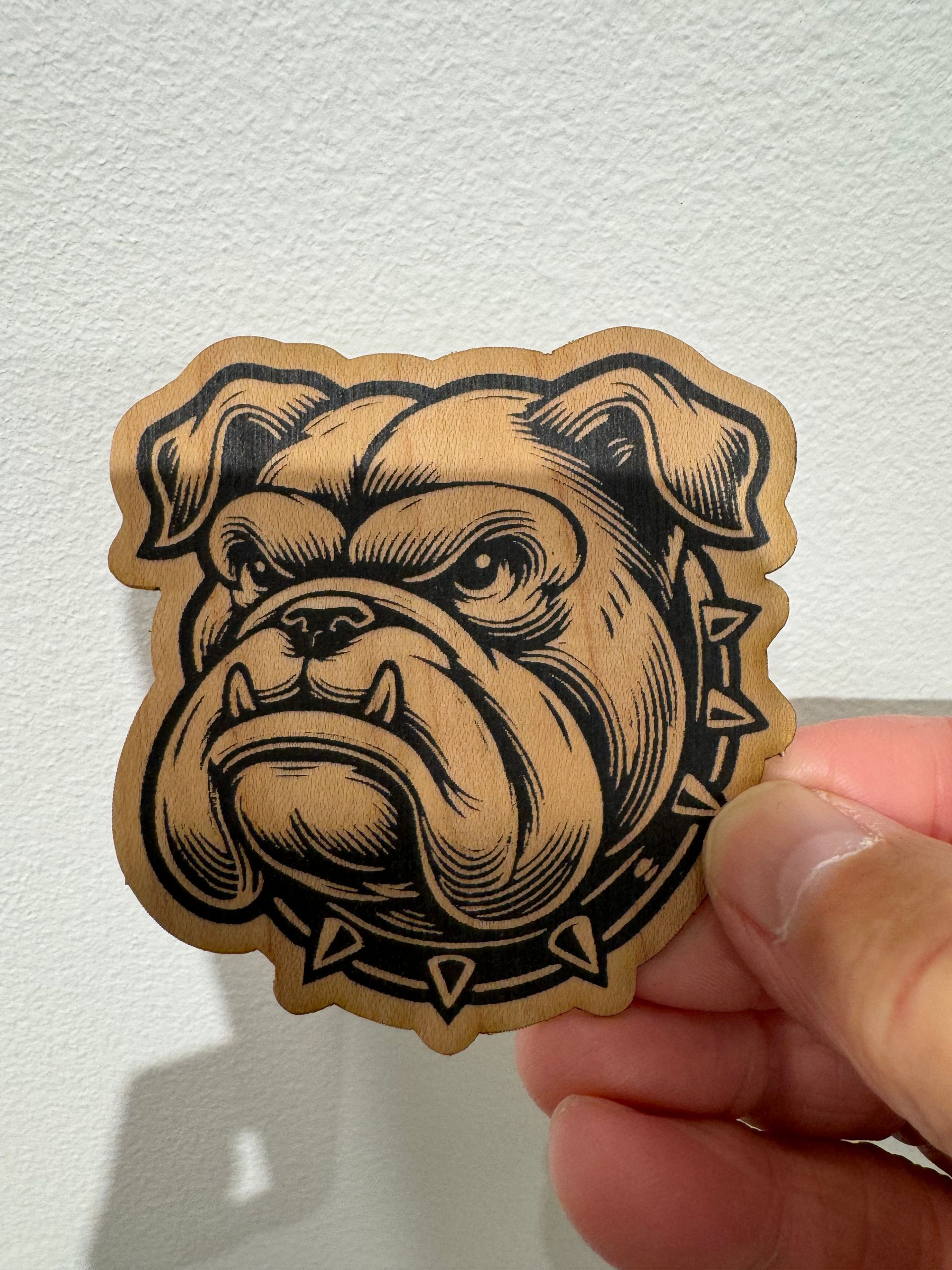 A person is holding a piece of paper with a picture of a bulldog on it
