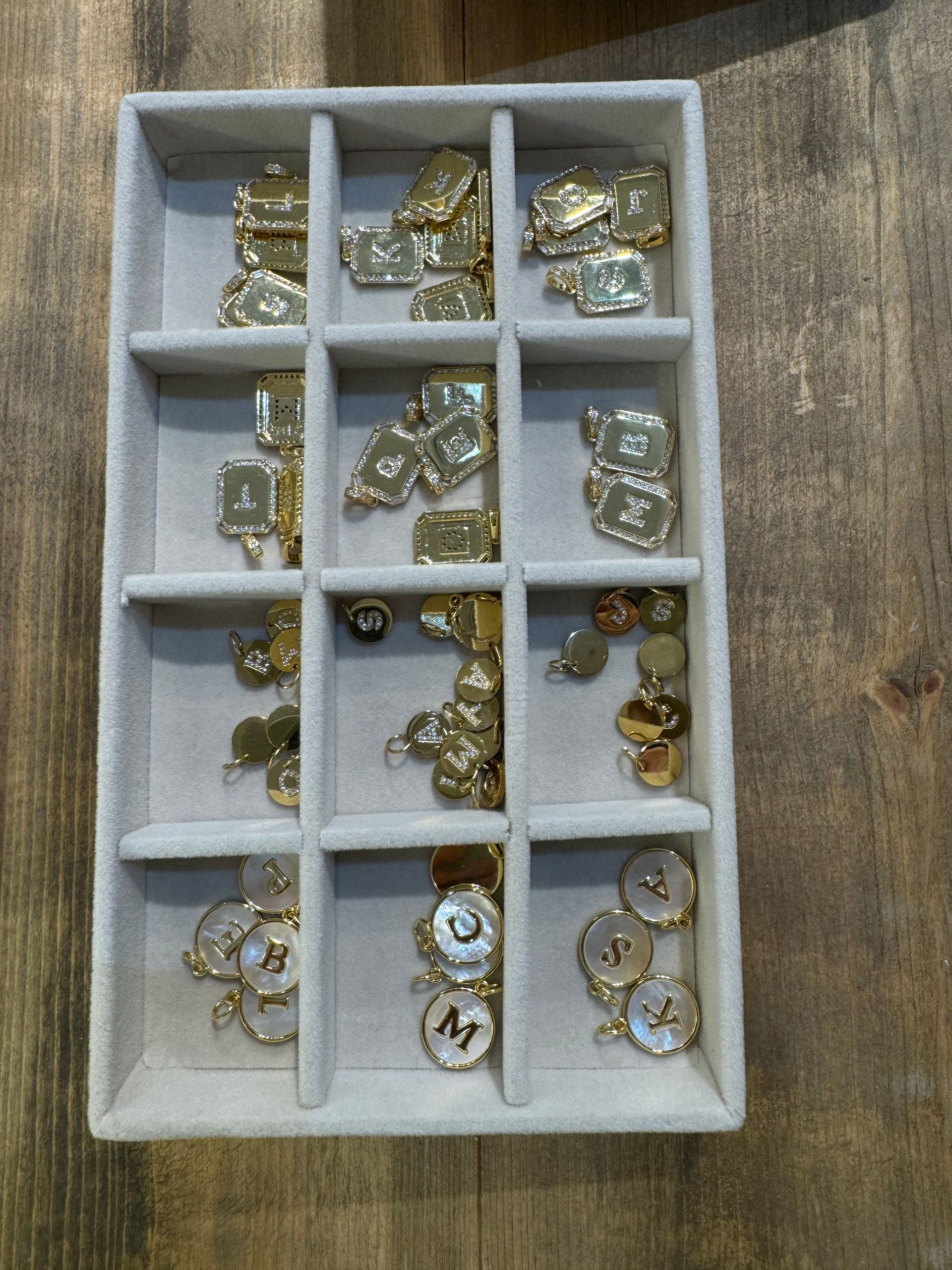 A tray filled with a variety of gold colored jewelry
