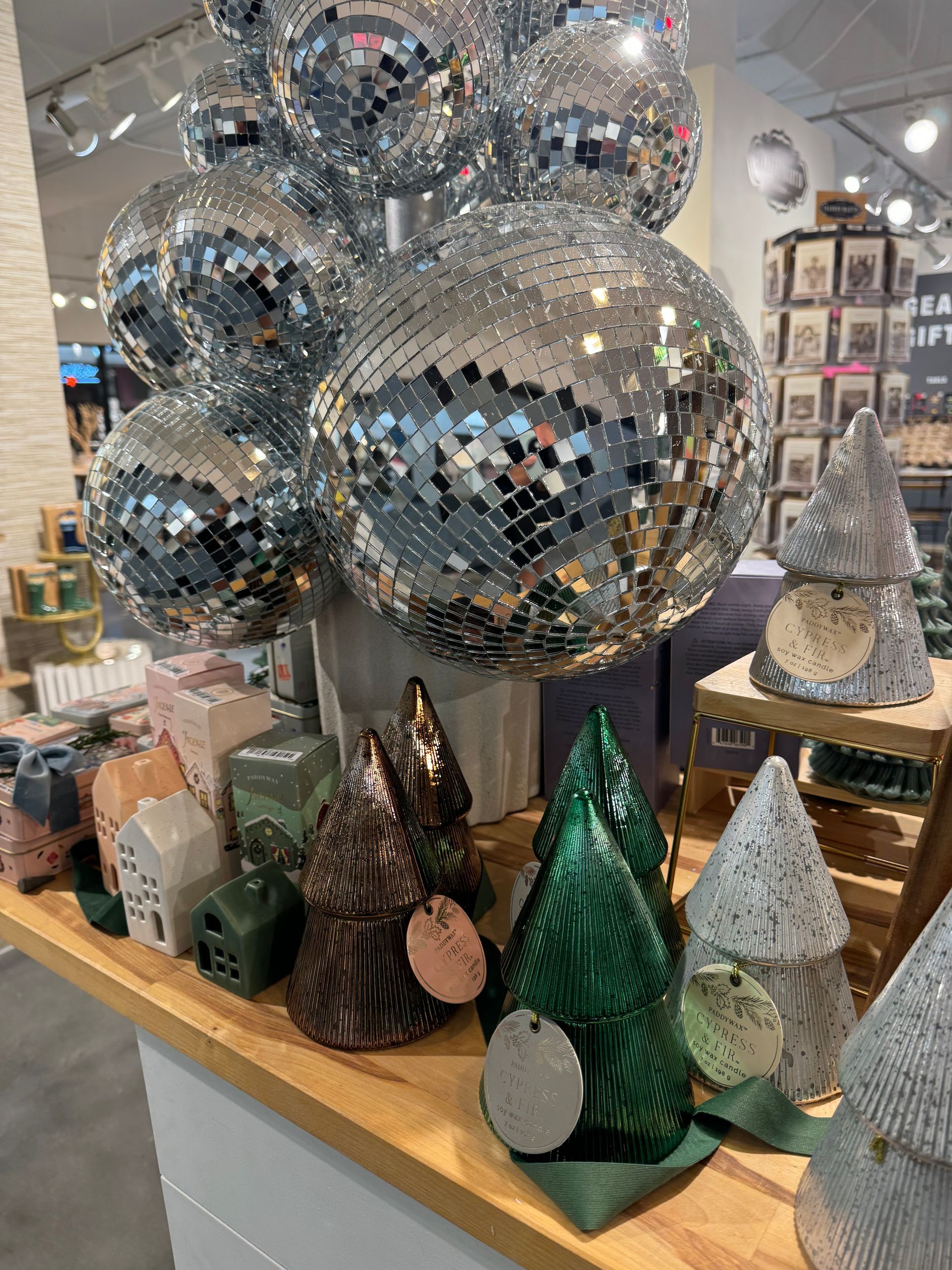 A bunch of disco balls are sitting on a table in a store