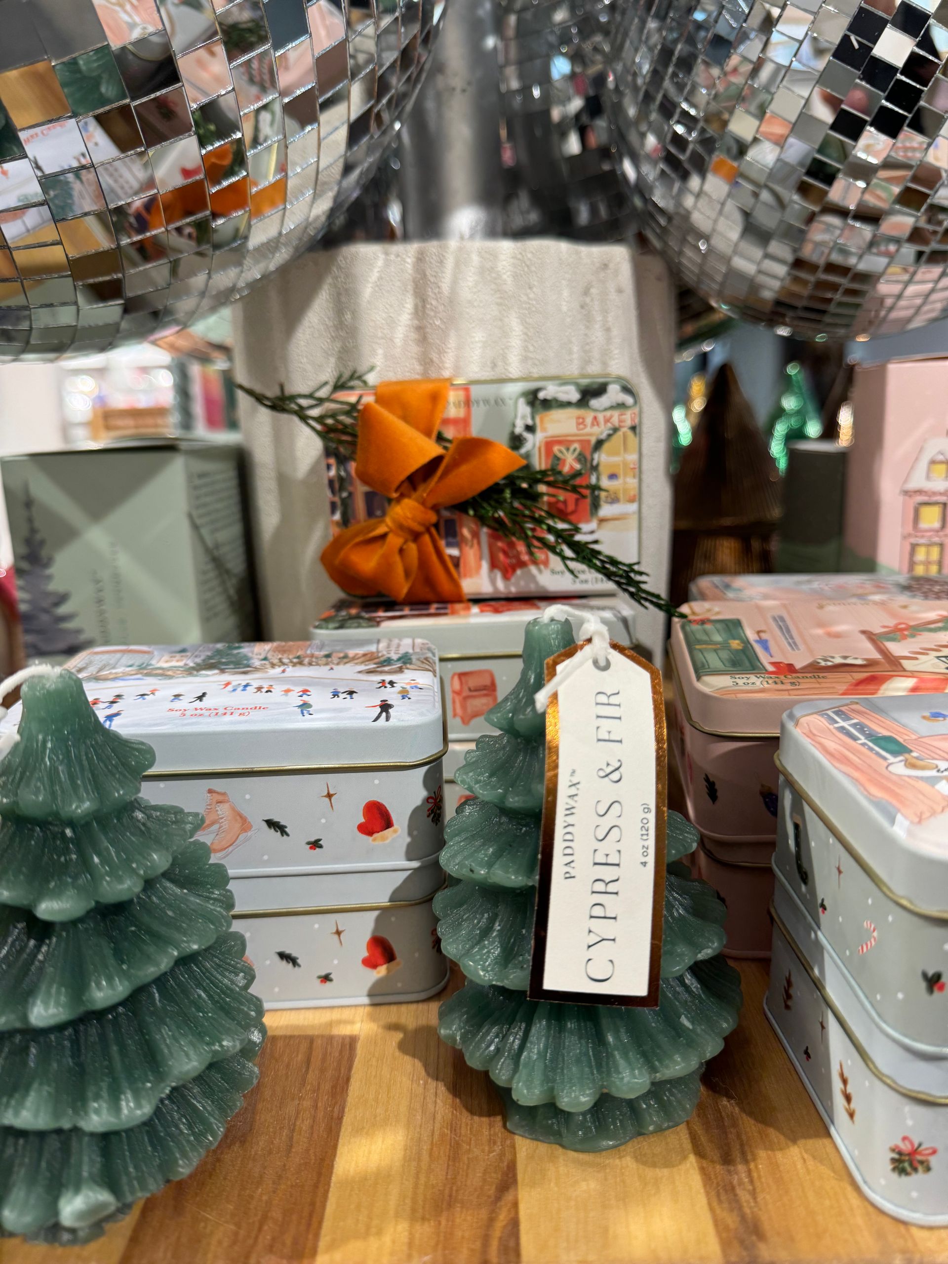 A christmas tree shaped candle with a tag on it