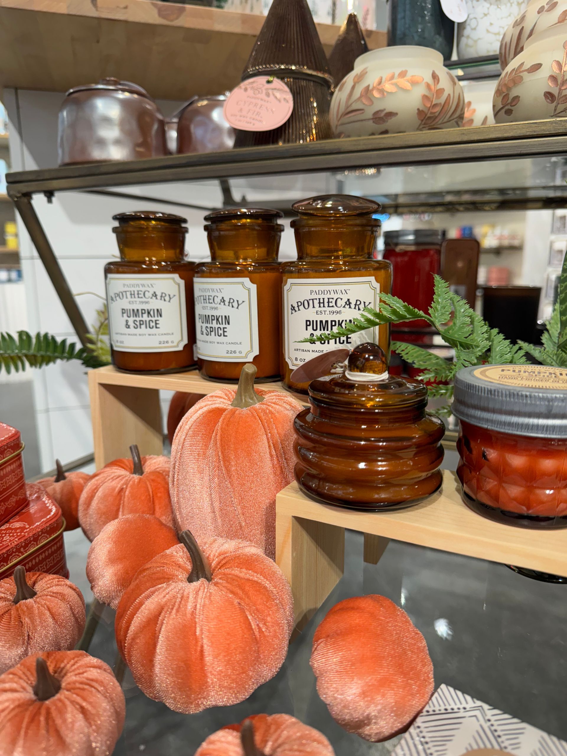 A display of candles and pumpkins in a store