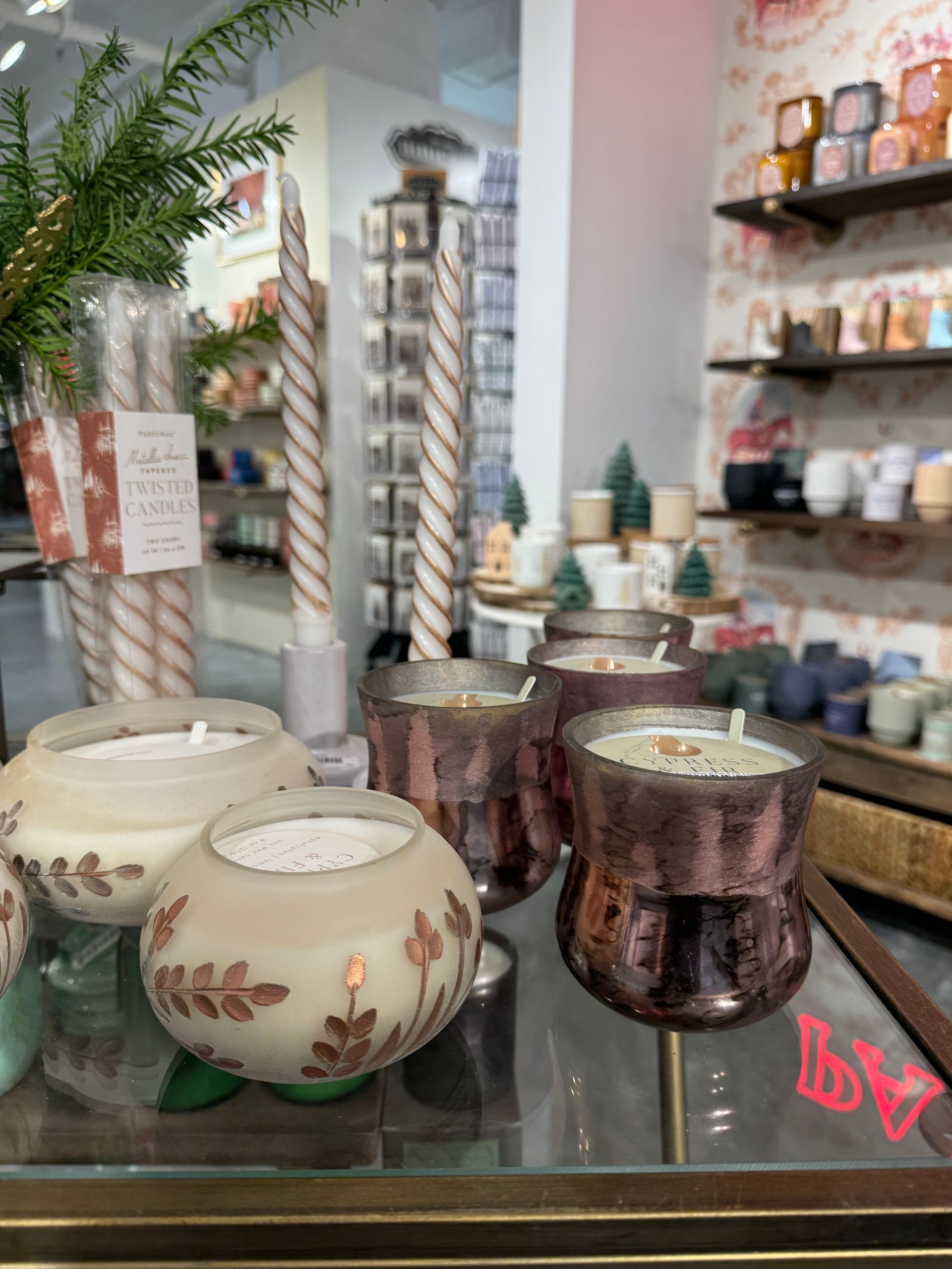 A display of candles in a store with a sign that says ' a ' on it
