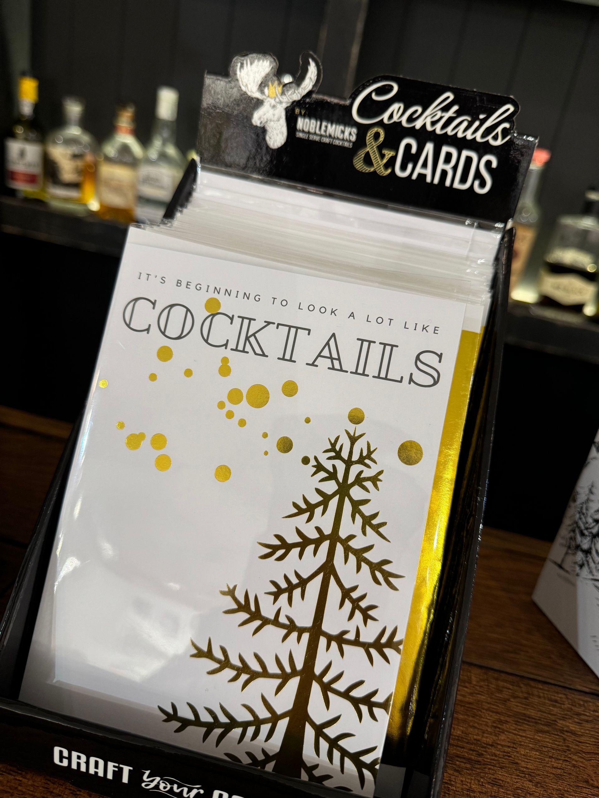 A box of cocktails and cards with a christmas tree on it