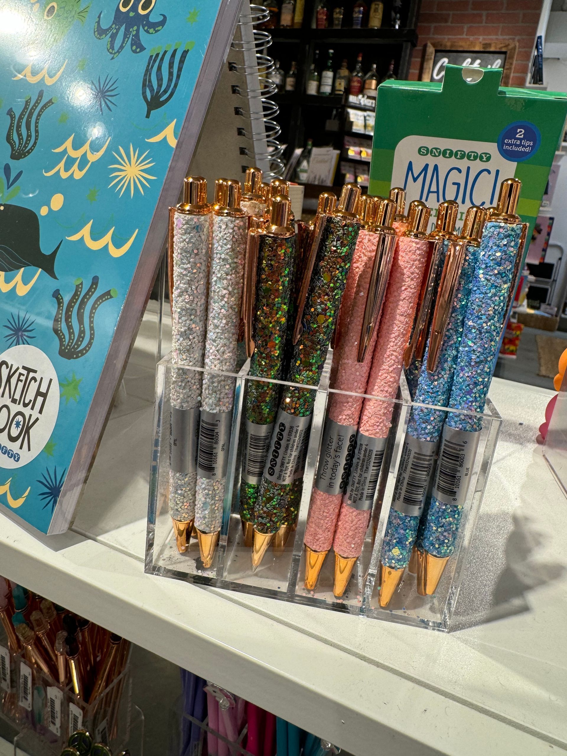 A display of pens with a box that says magic on it