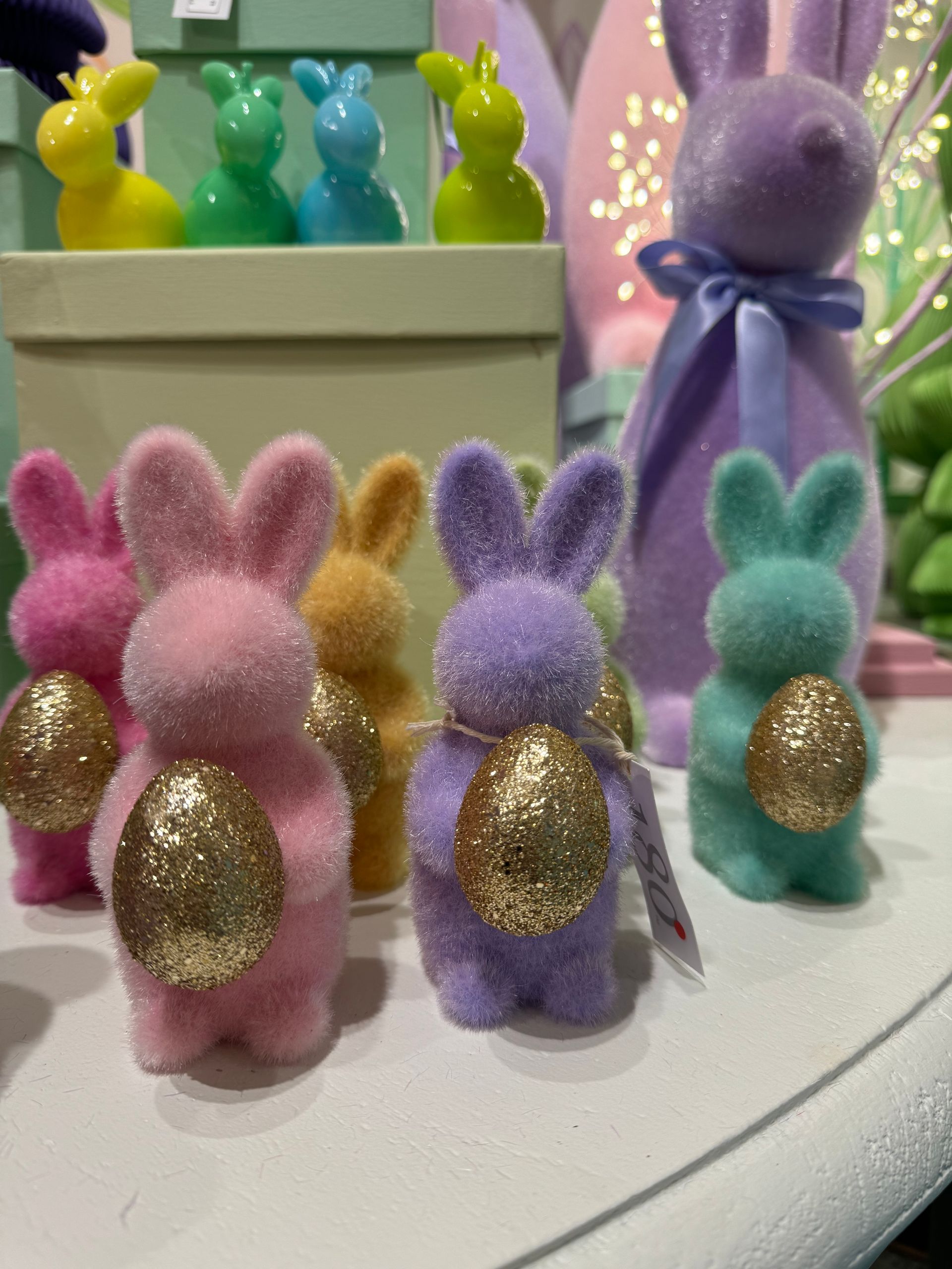 A bunch of stuffed bunny rabbits are sitting on a table