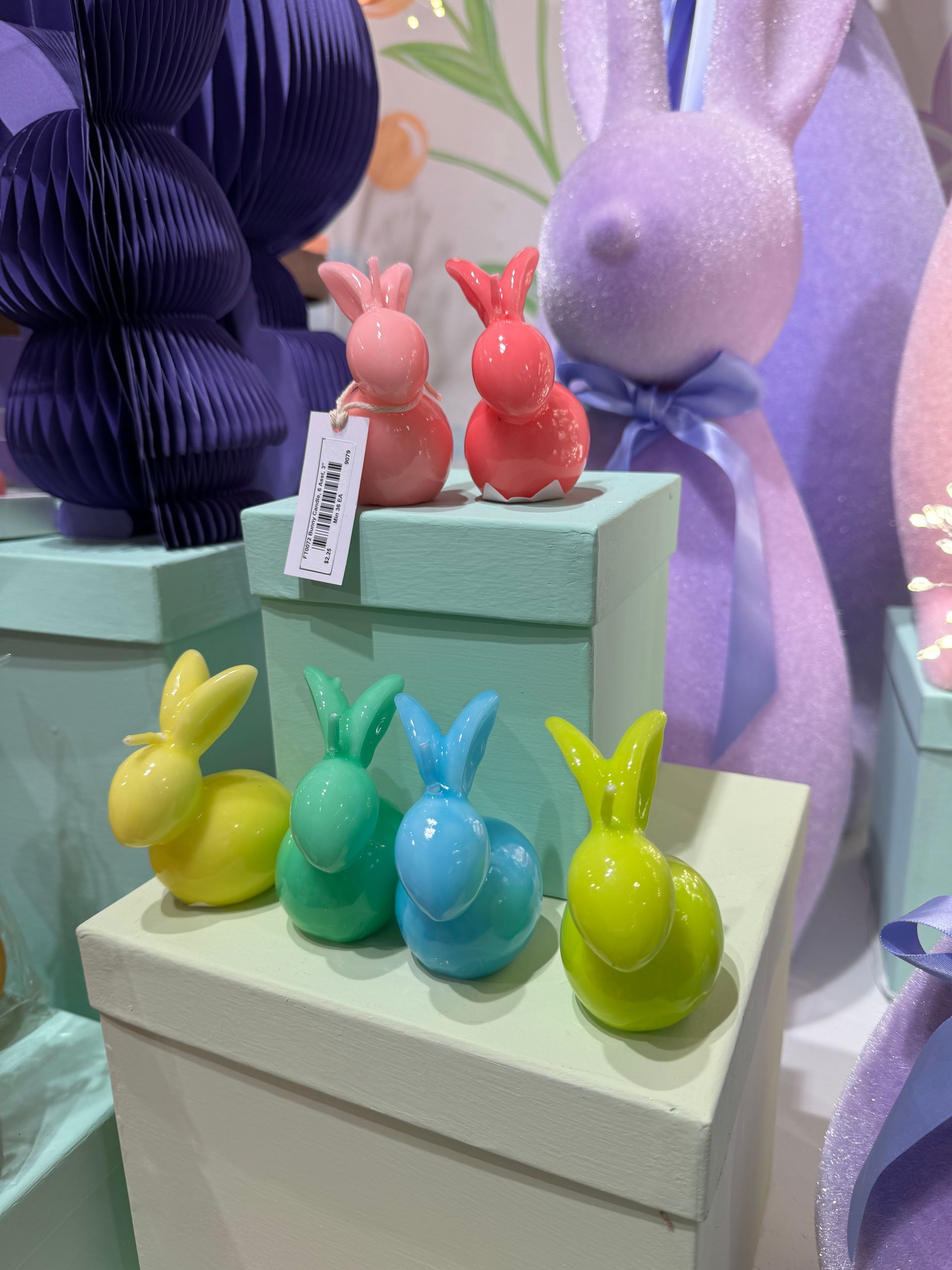 A bunch of bunny figurines are sitting on top of boxes