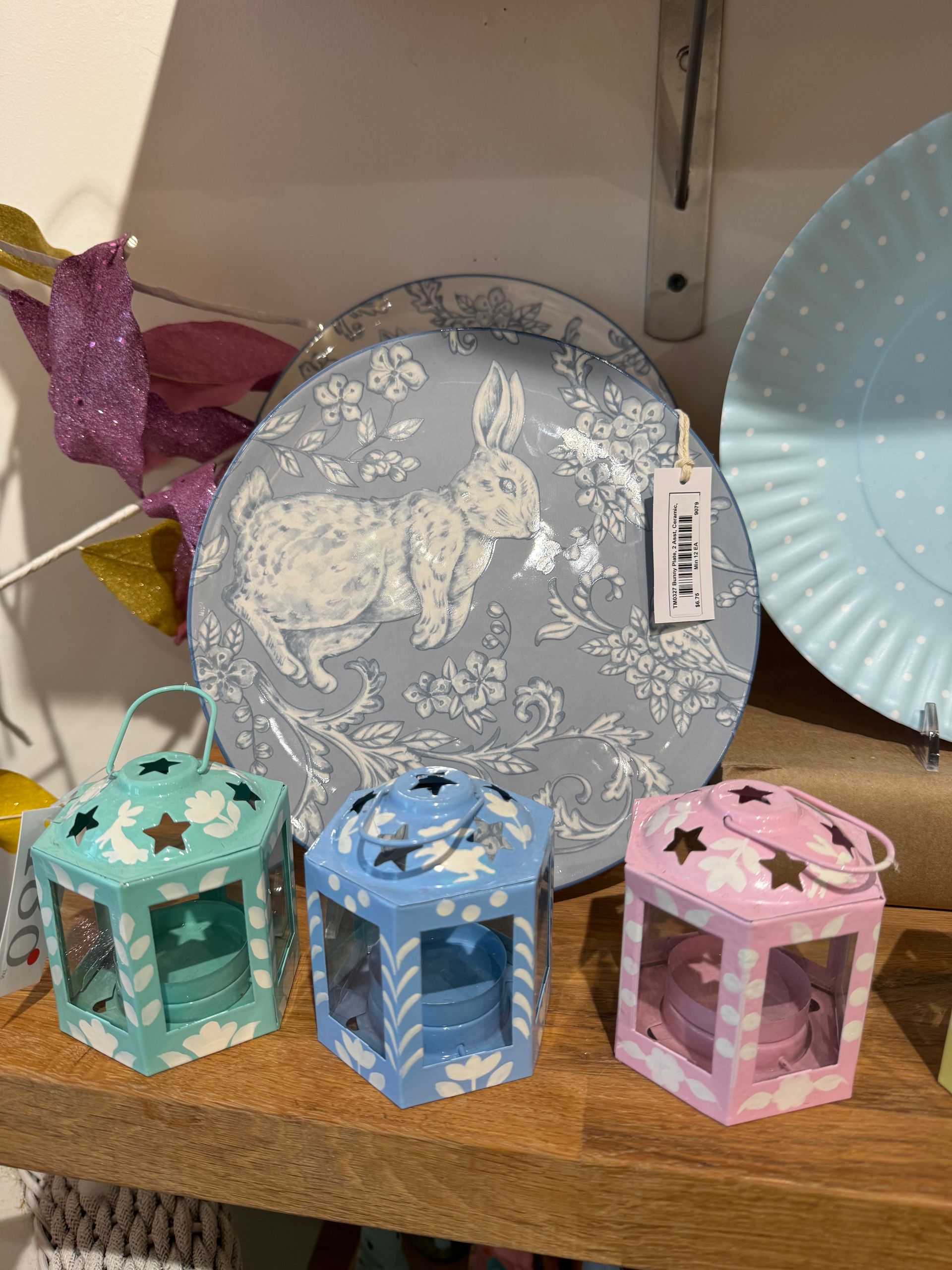 A plate with a rabbit on it is on a wooden shelf