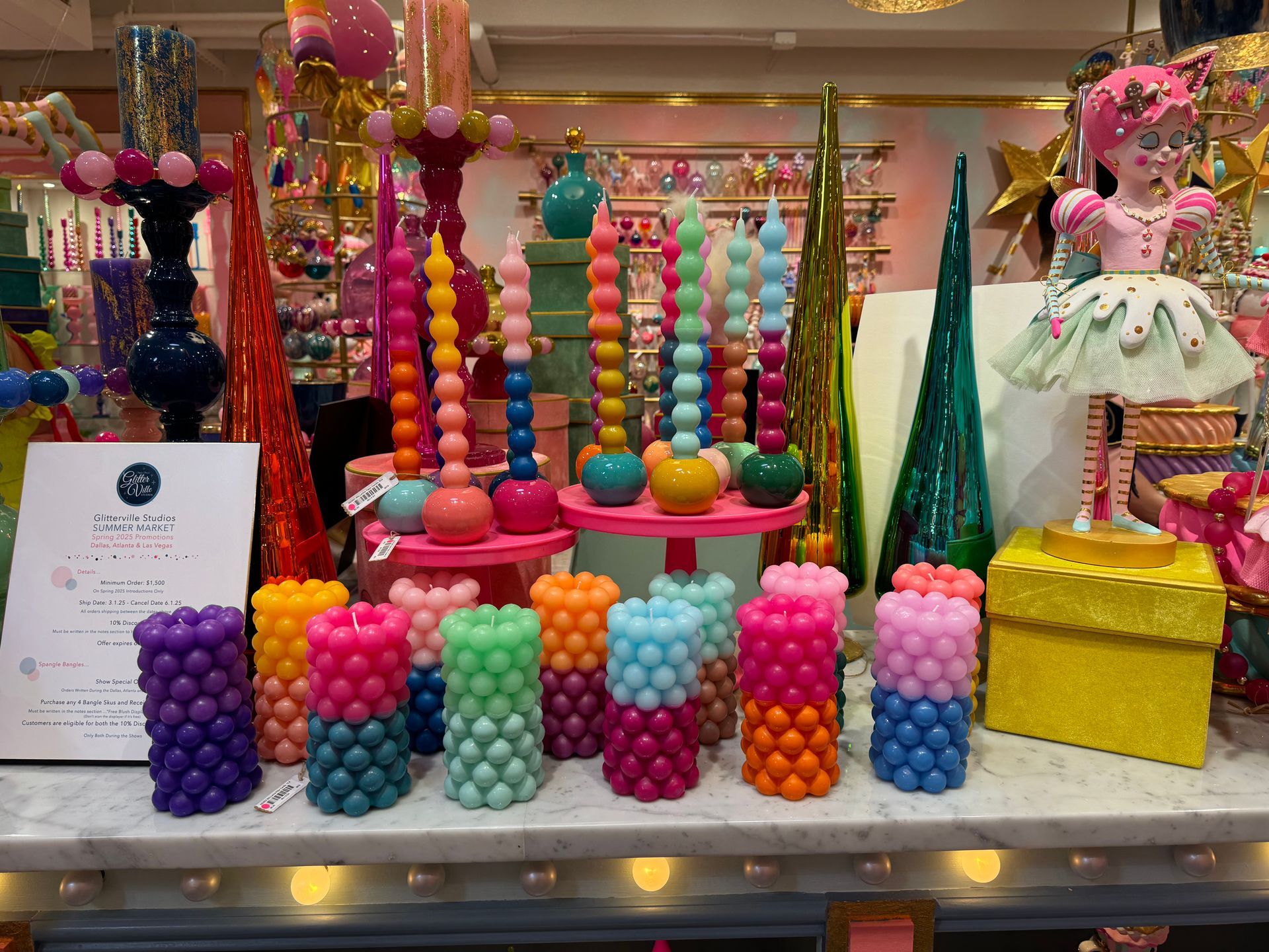 A bunch of colorful candles are on display on a table