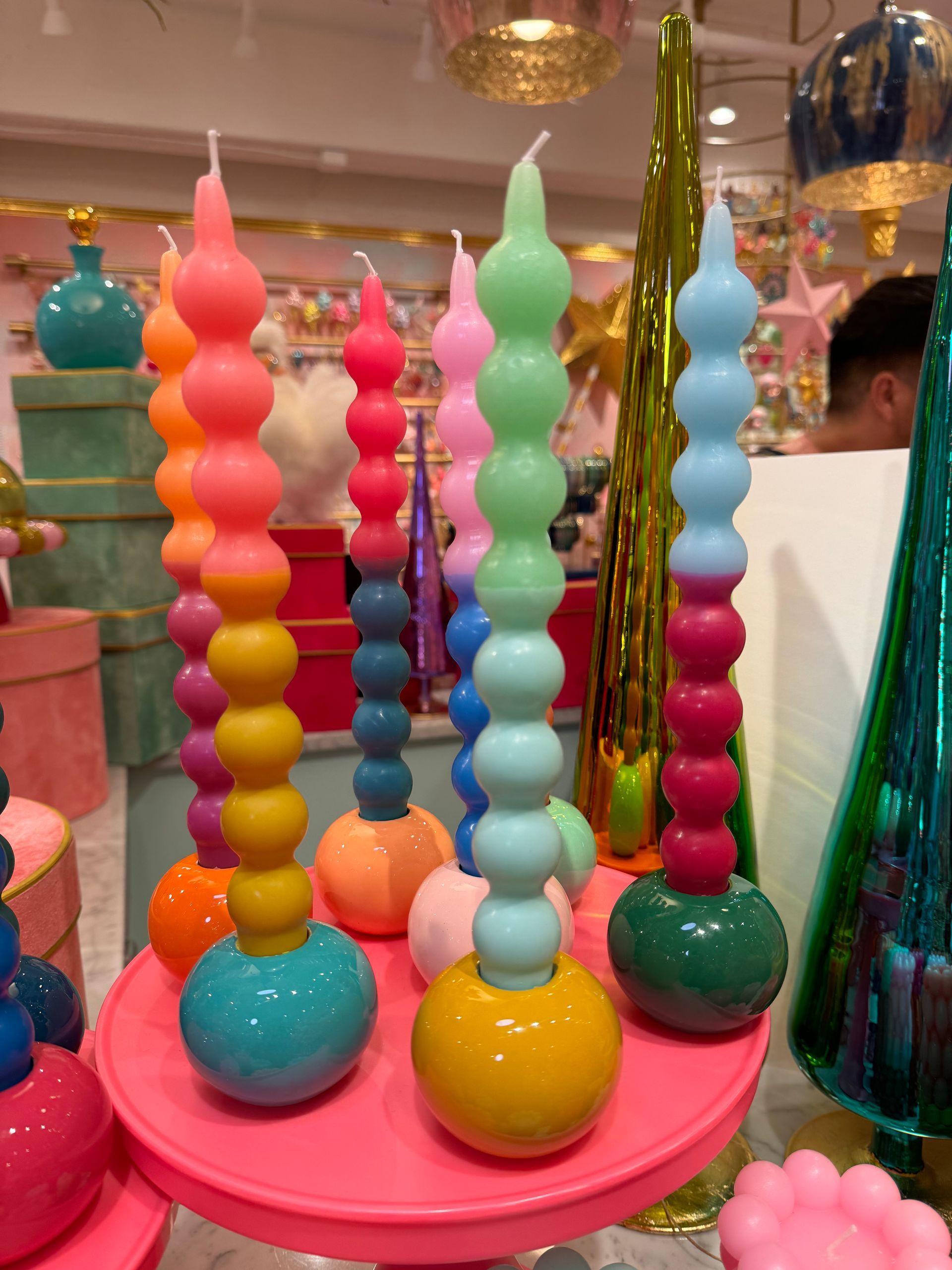 A bunch of colorful candles on a pink plate