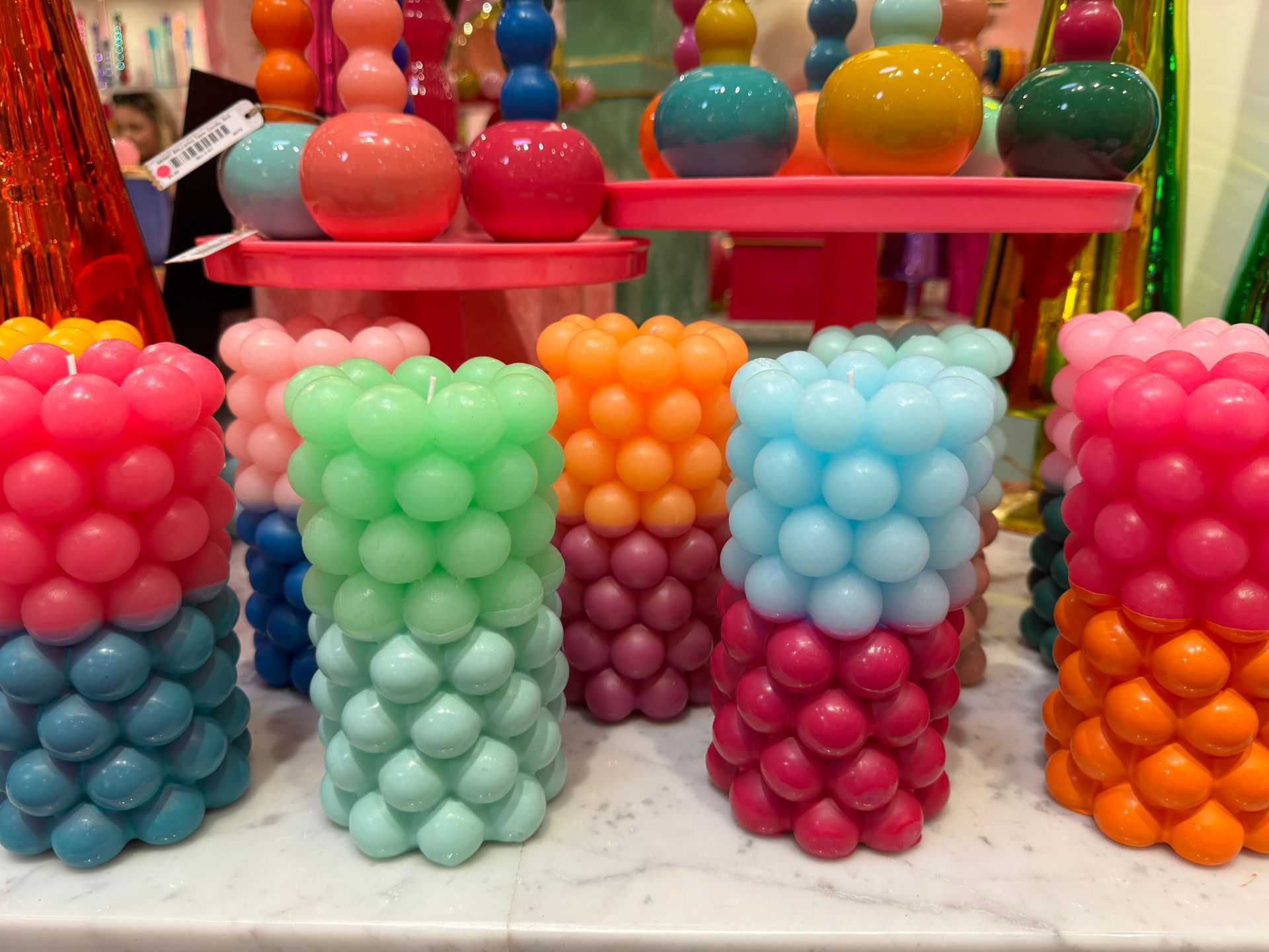 A bunch of different colored candles on a table