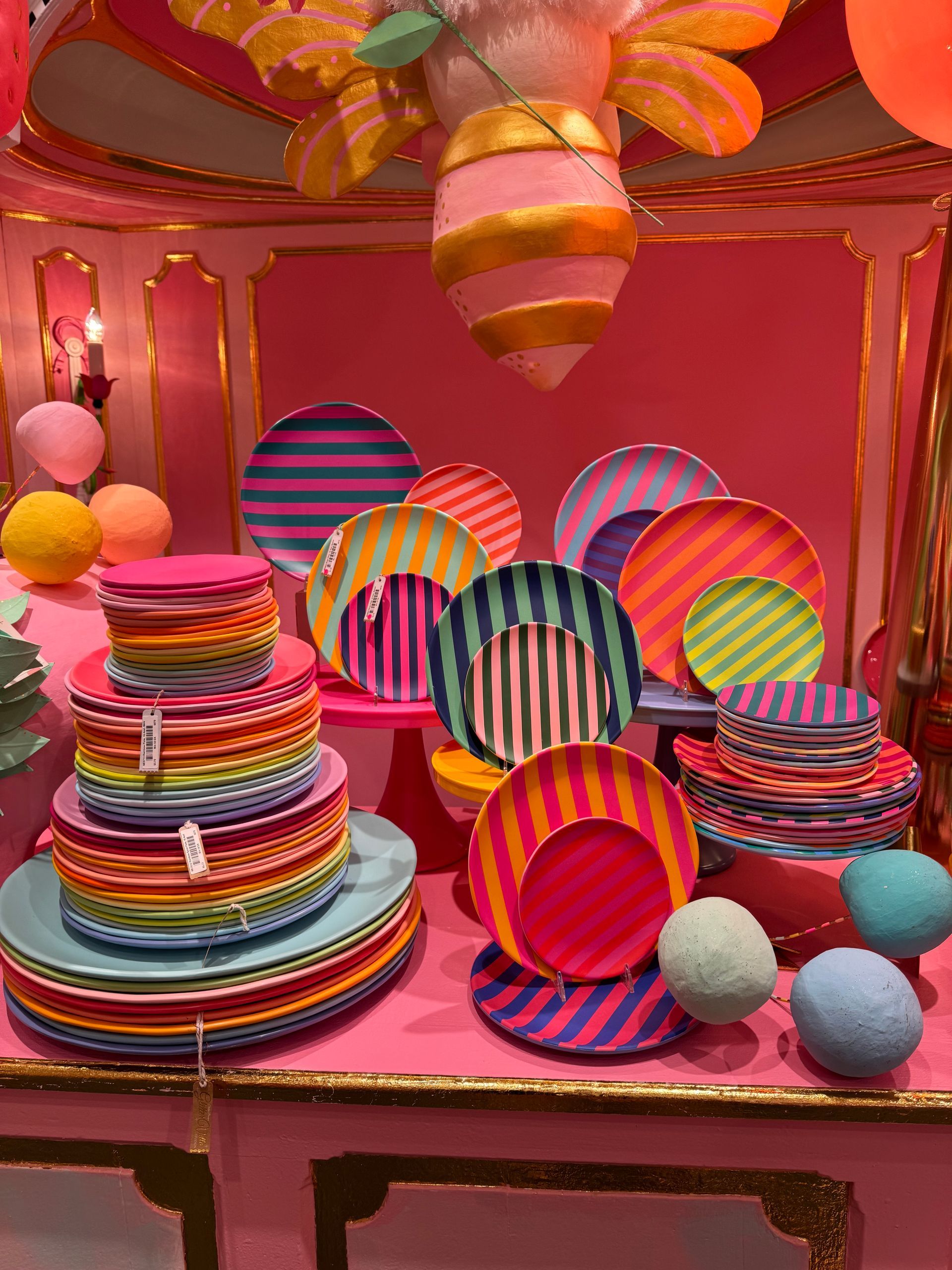 A bunch of colorful plates are stacked on top of each other on a table