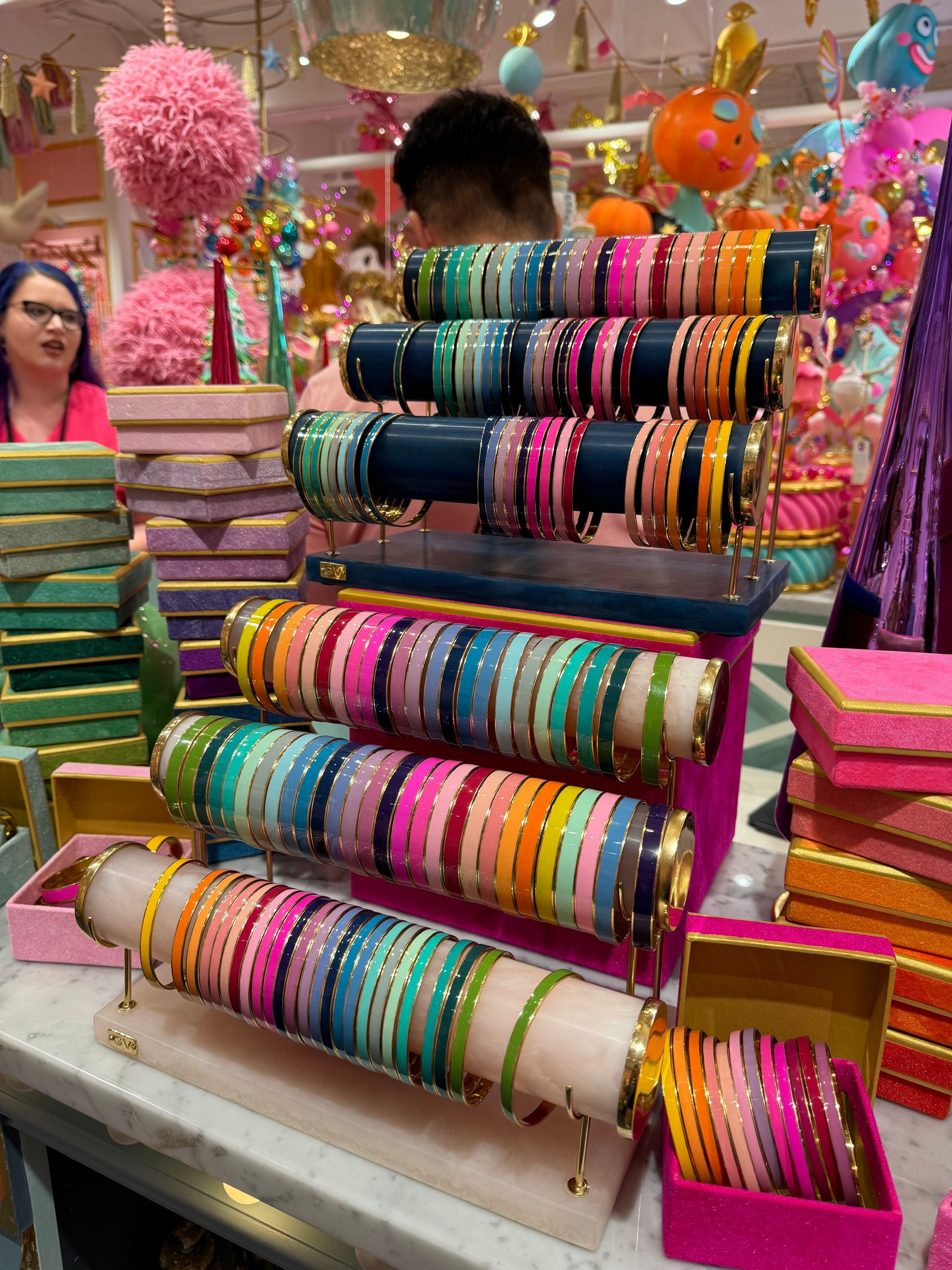 A bunch of colorful bracelets on display in a store