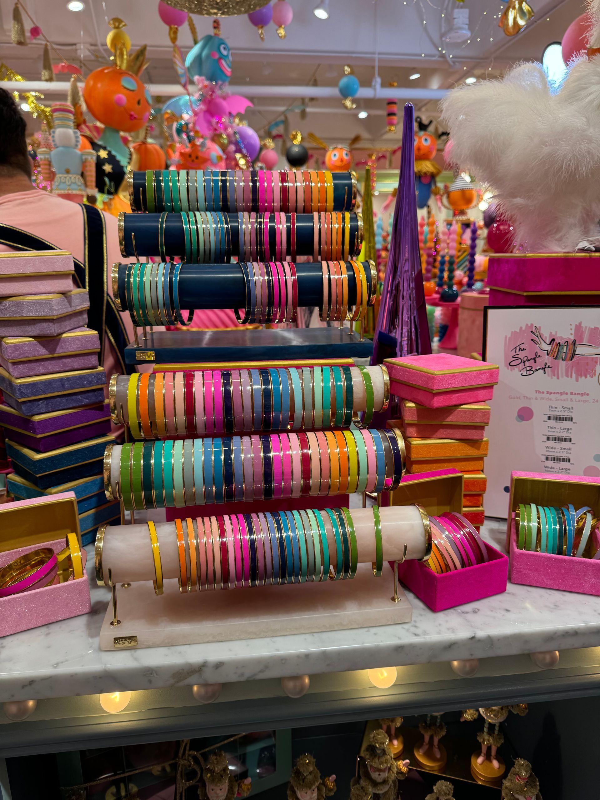 A bunch of colorful bracelets on display in a store