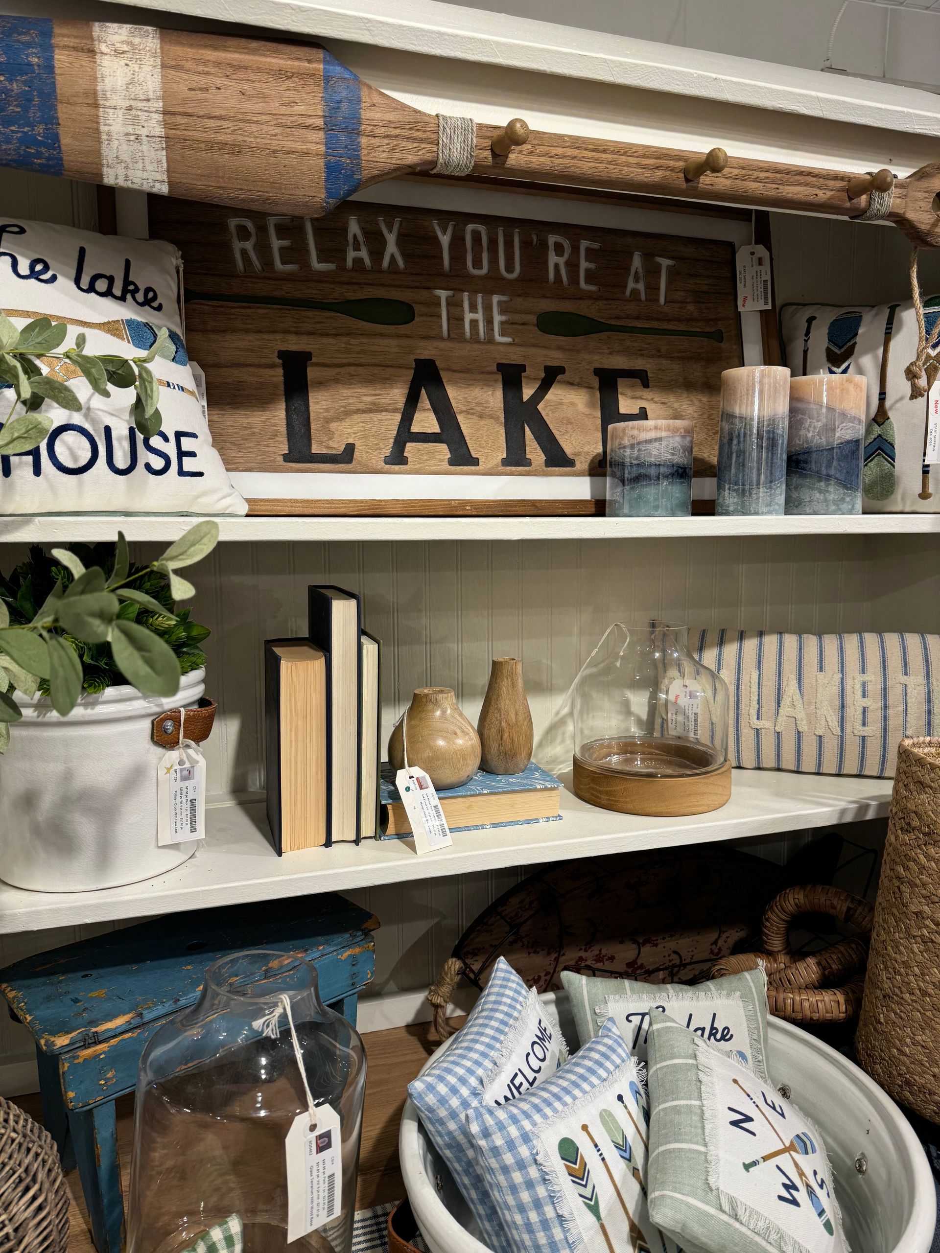A shelf with a sign that says relax you re at the lake
