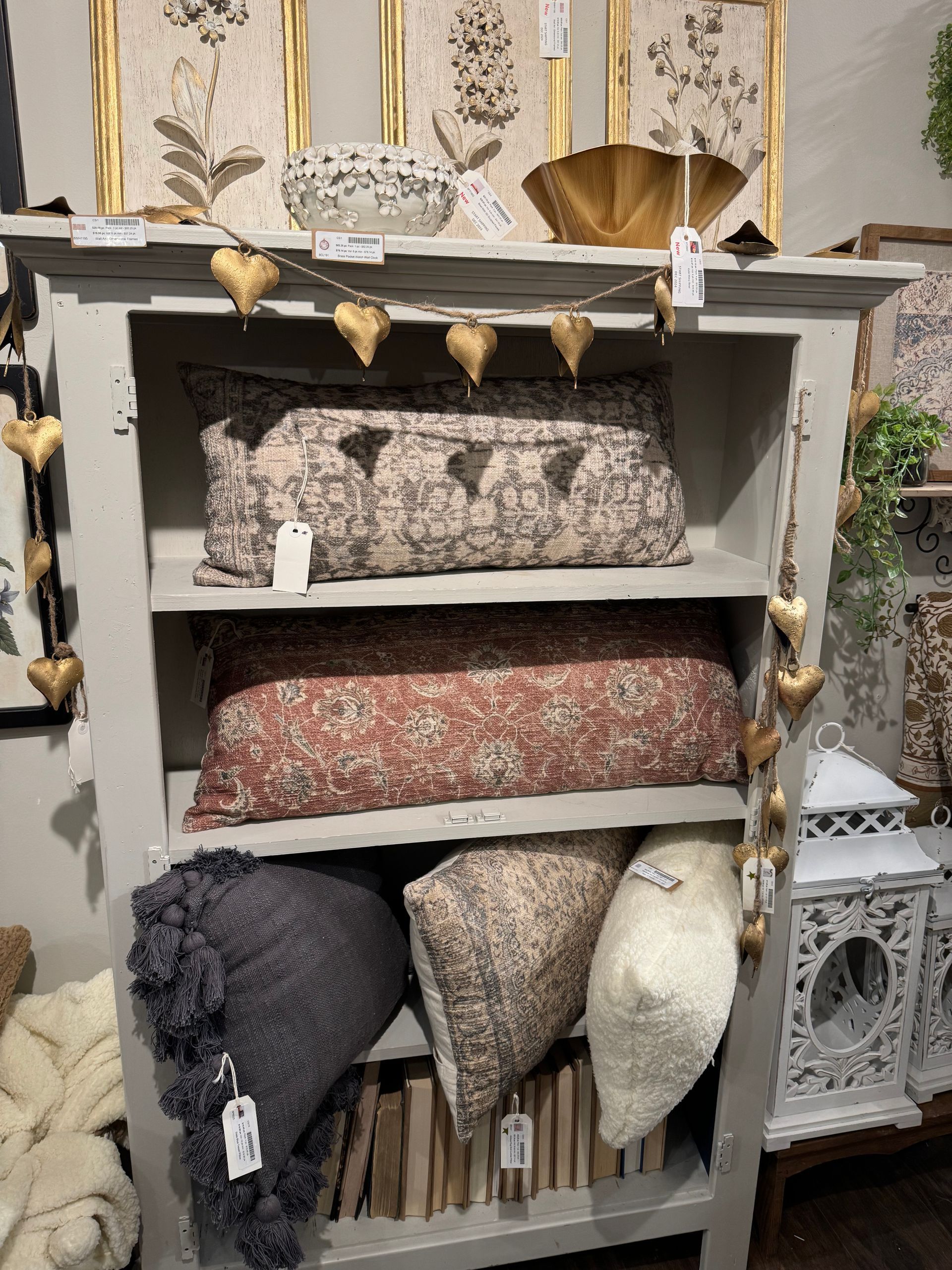 A shelf filled with lots of pillows and blankets