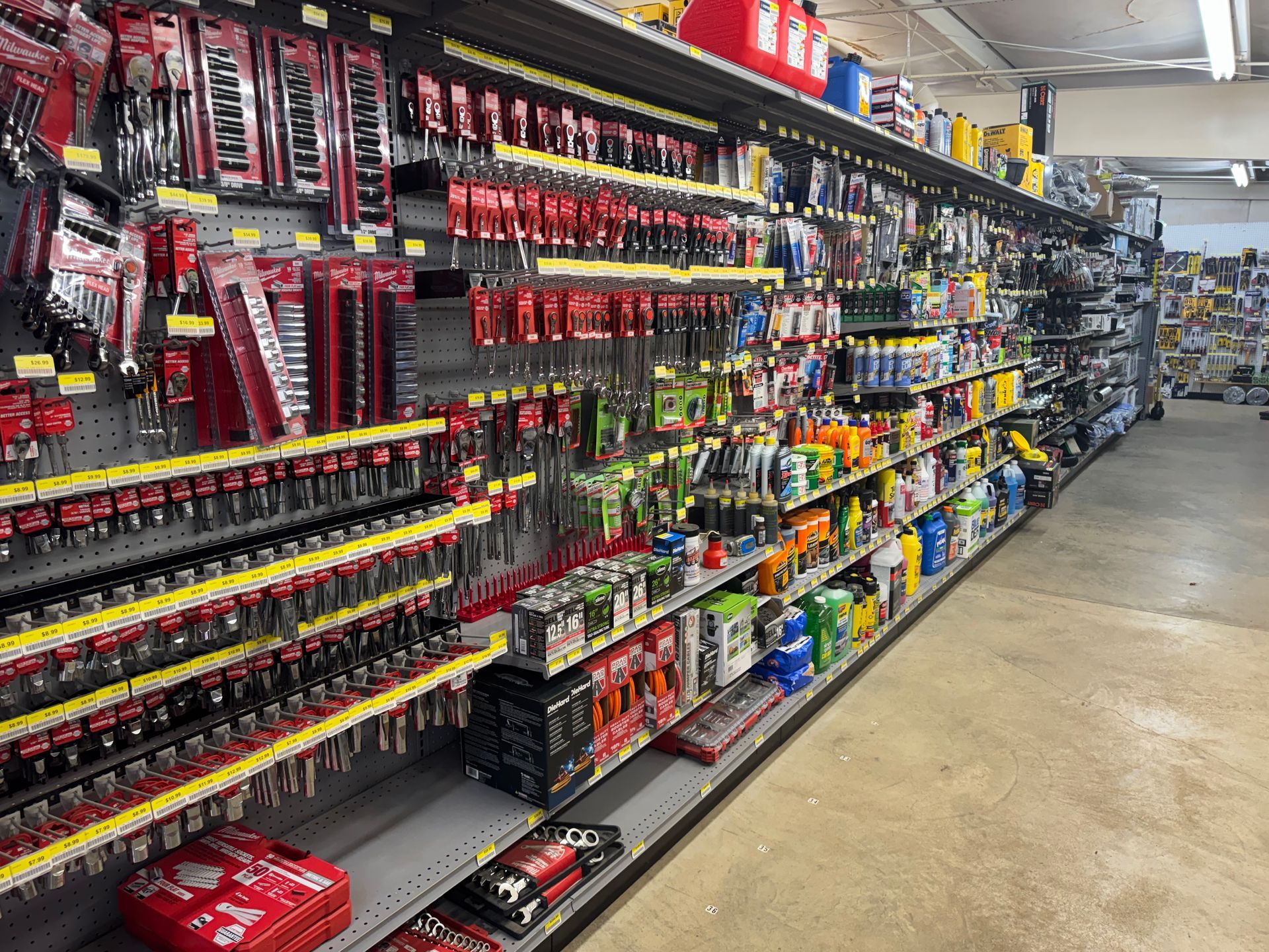 Hardware store interior with shelves displaying tools and supplies.