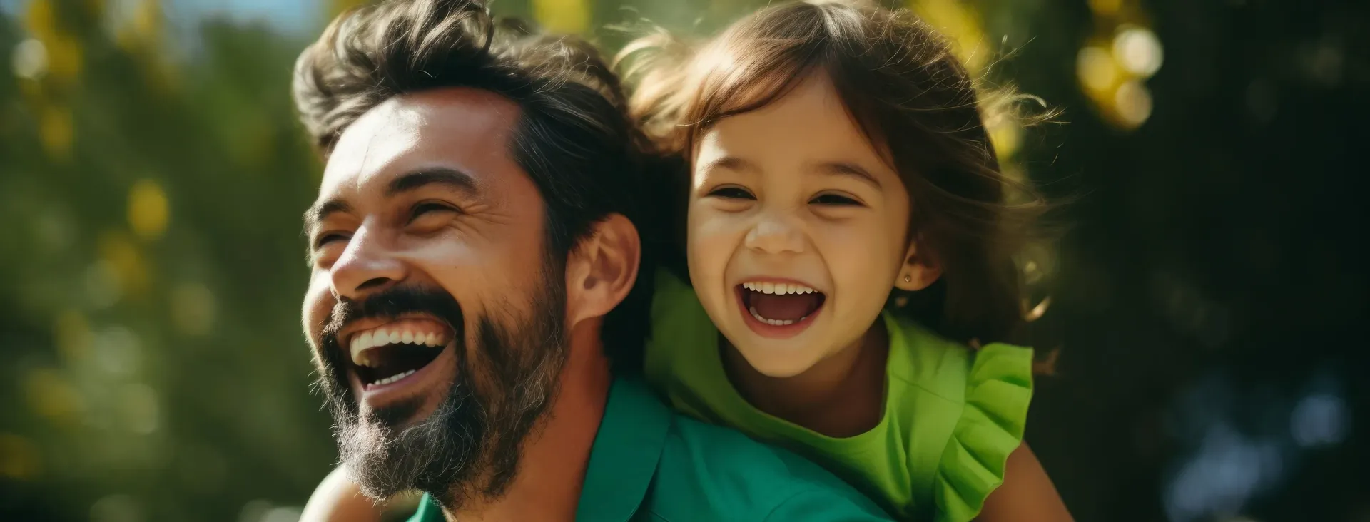 A man is carrying a little girl on his shoulders.