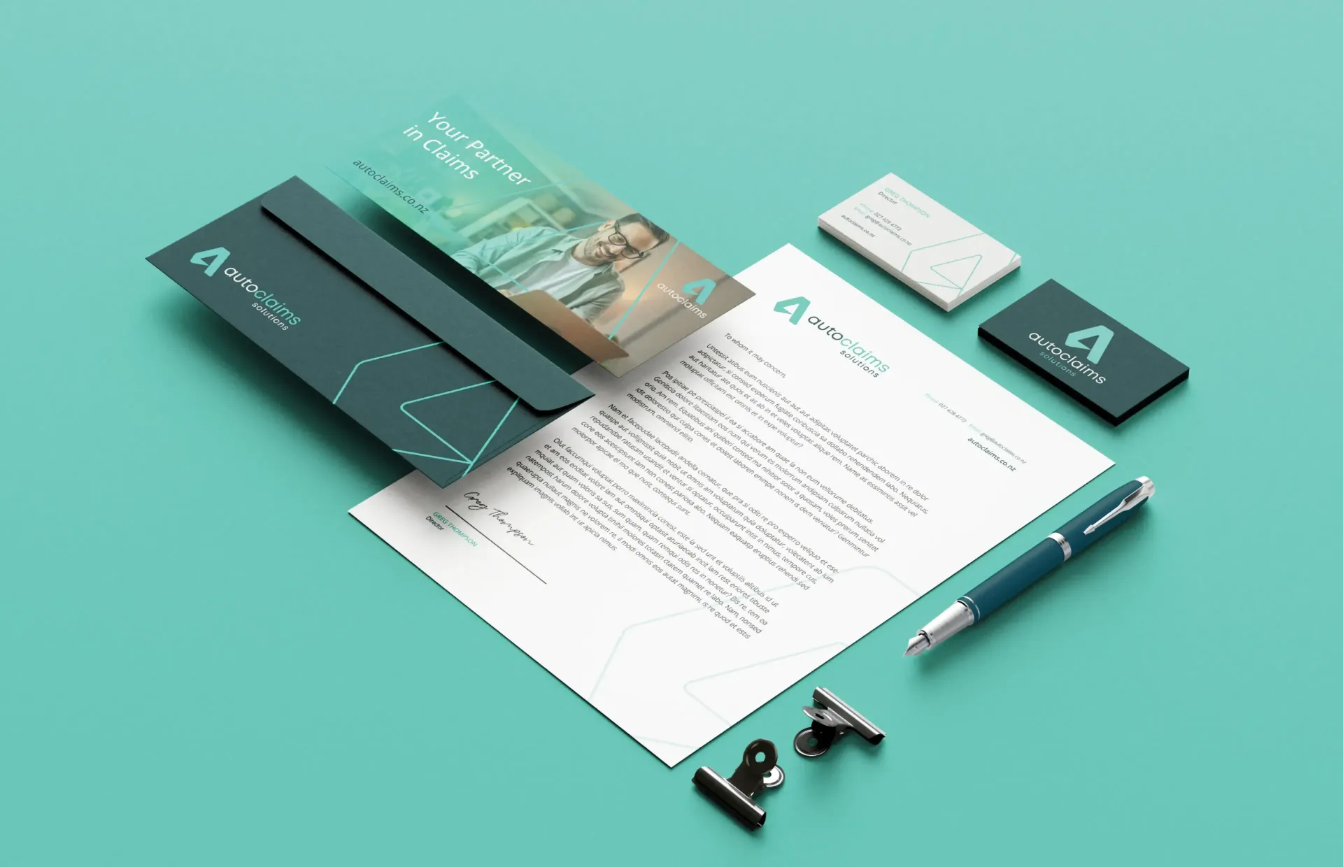 Stationery set in teal: letterhead, envelope, business card, pen, and paperclip.