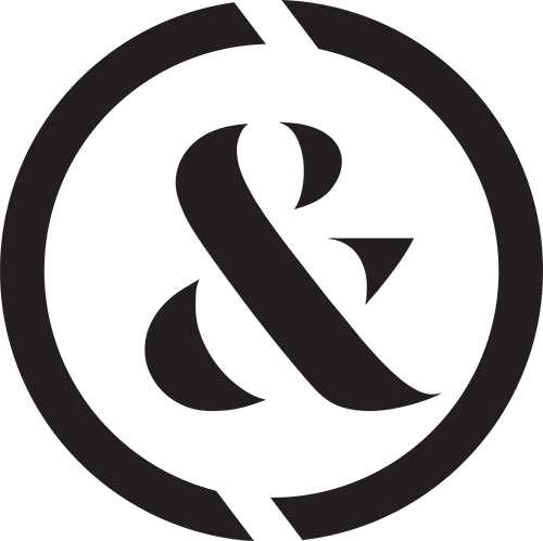Black ampersand inside a black circle bisected by two white lines.