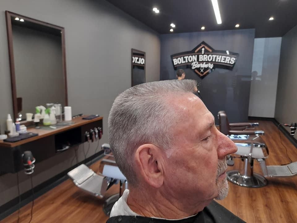Man With Gray Hair Getting Haircut — Bolton Brothers Barbers in Erina, NSW