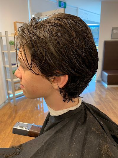 Person With Dark Wet Hair In Side Profile — Bolton Brothers Barbers in Erina, NSW