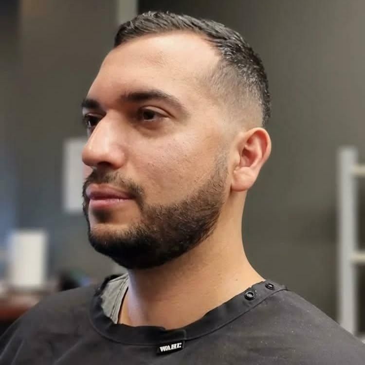 Man With Fade Haircut And Beard Wearing Black Cape — Bolton Brothers Barbers in Erina, NSW