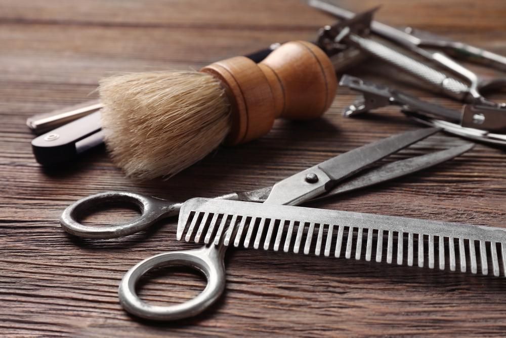 Barber Tools On Wooden Surface — Bolton Brothers Barbers in Erina, NSW