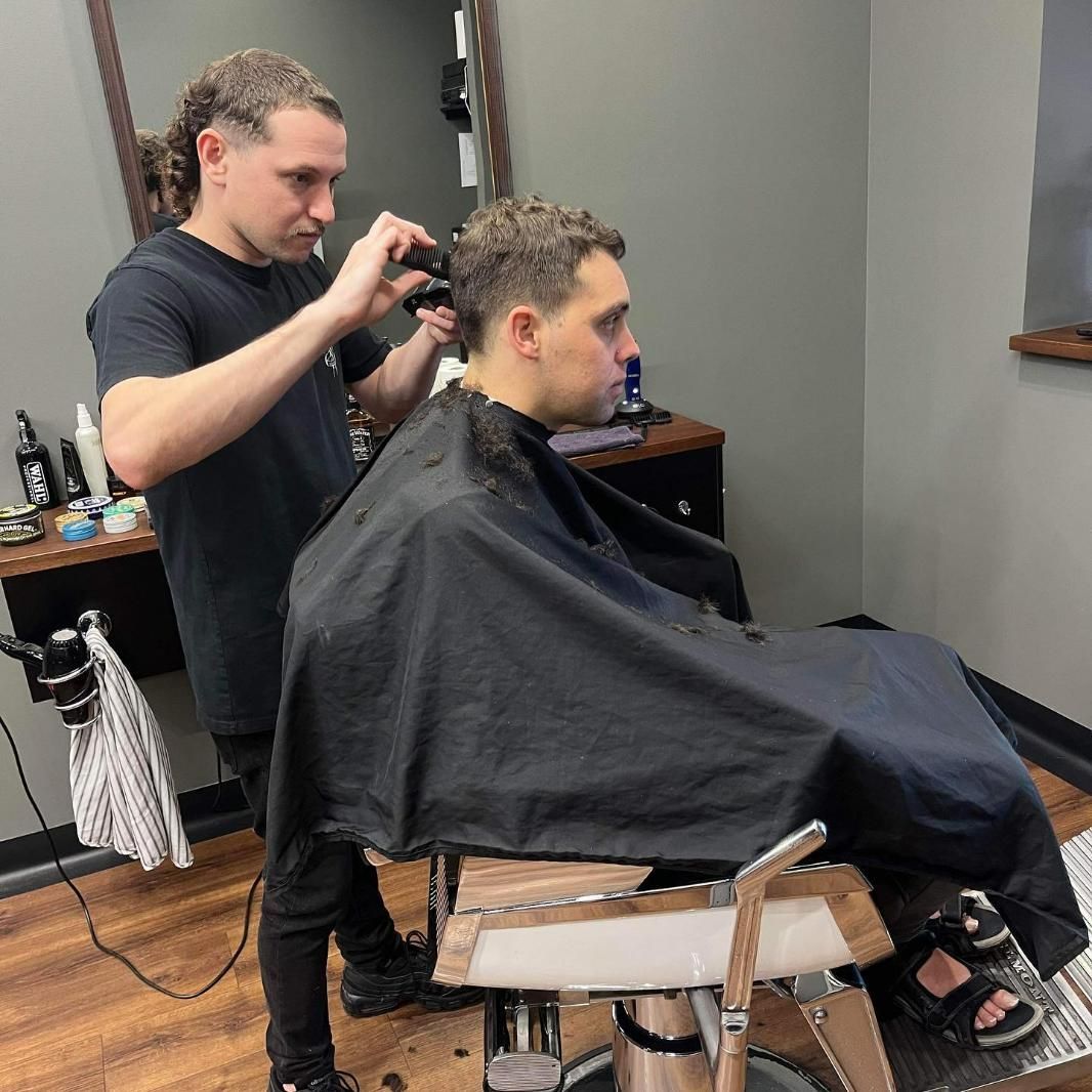 Barber Cutting Man's Hair In Barbershop — Bolton Brothers Barbers in Erina, NSW