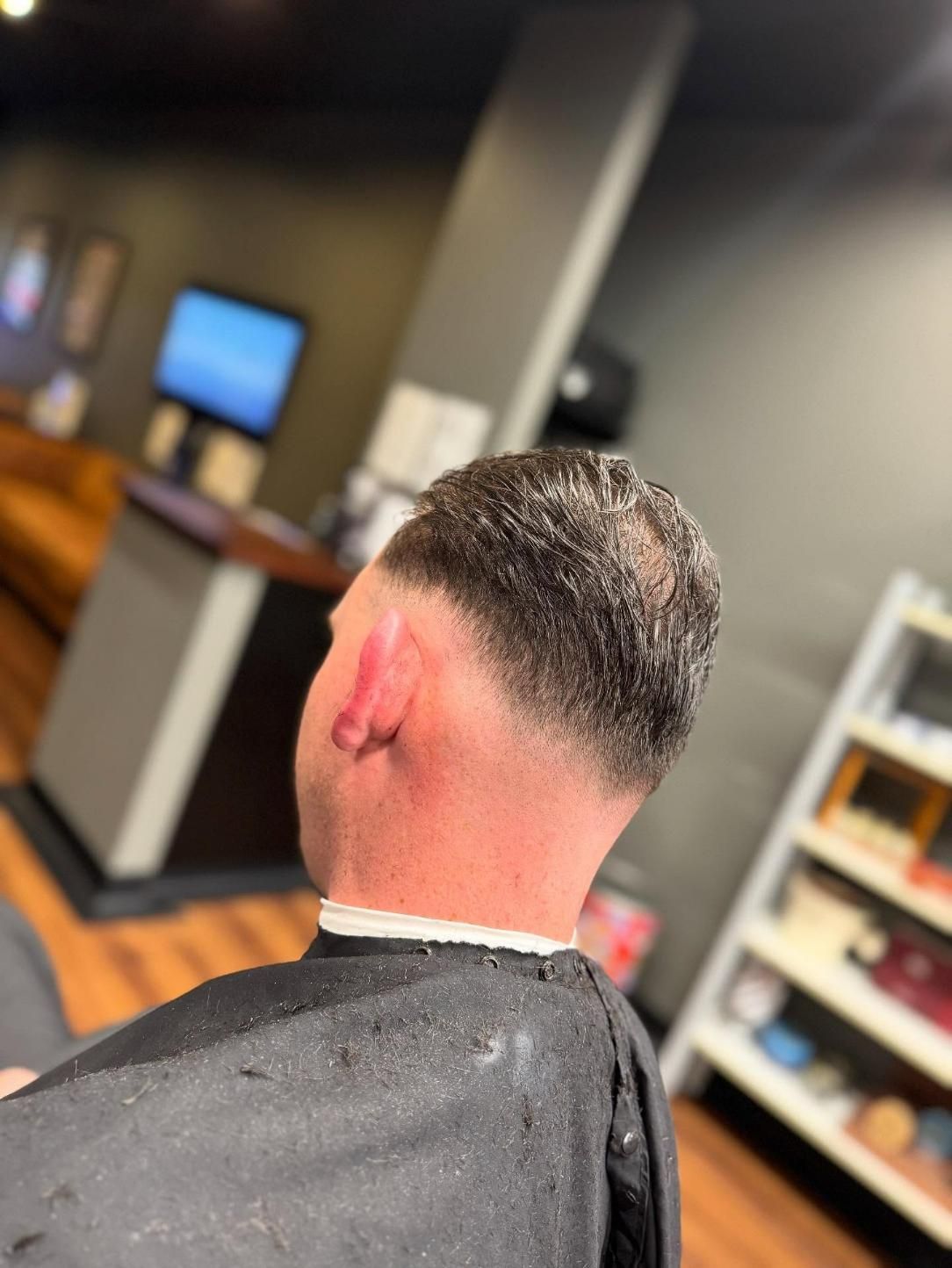 Man With Fresh Skin-Fade Haircut In Barber Chair — Bolton Brothers Barbers in Erina, NSW