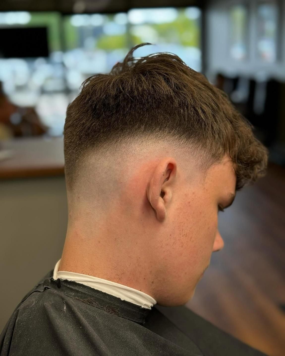 Man With Dark Hair Fade Haircut Seated — Bolton Brothers Barbers in Erina, NSW