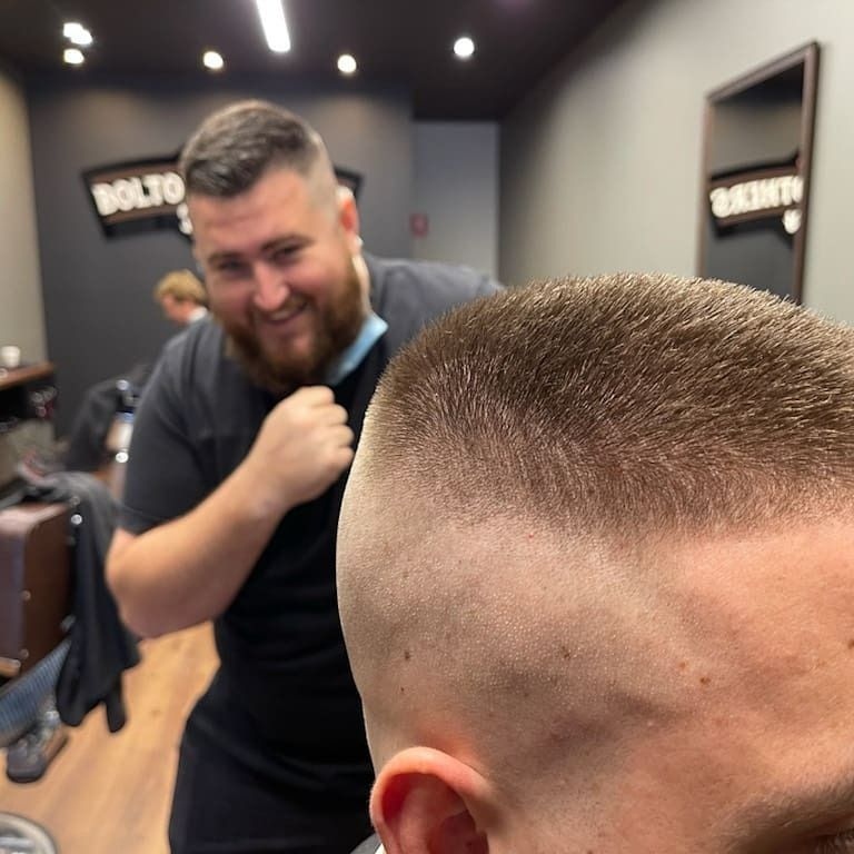 Barber Giving Fade Haircut While Smiling — Bolton Brothers Barbers in Erina, NSW