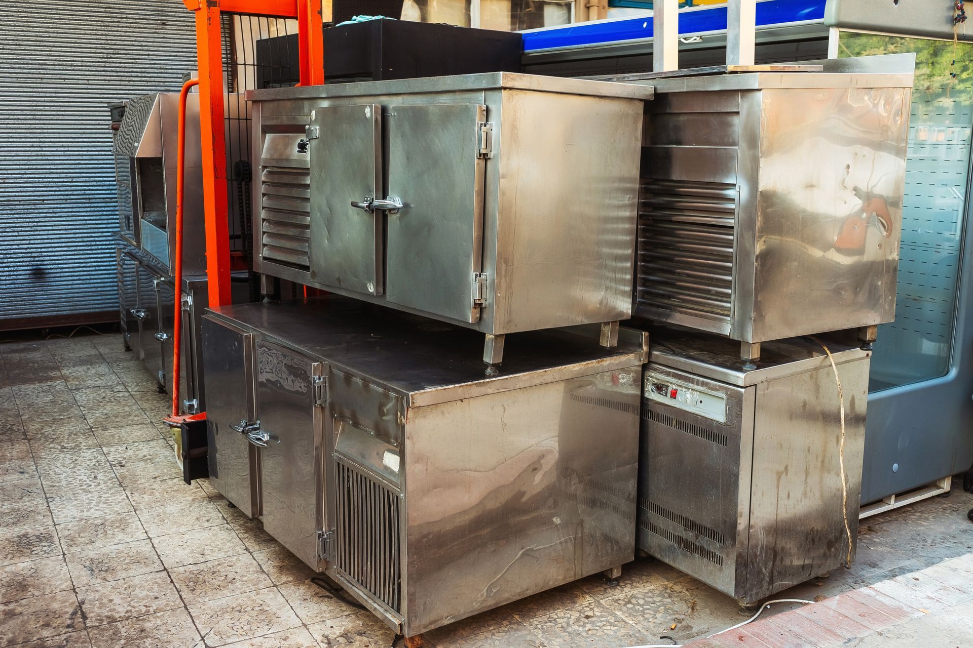 Old refrigeration equipment for restaurants on top of each other outdoors. Old refrigeration equipment for restaurants on top of each other outdoors.