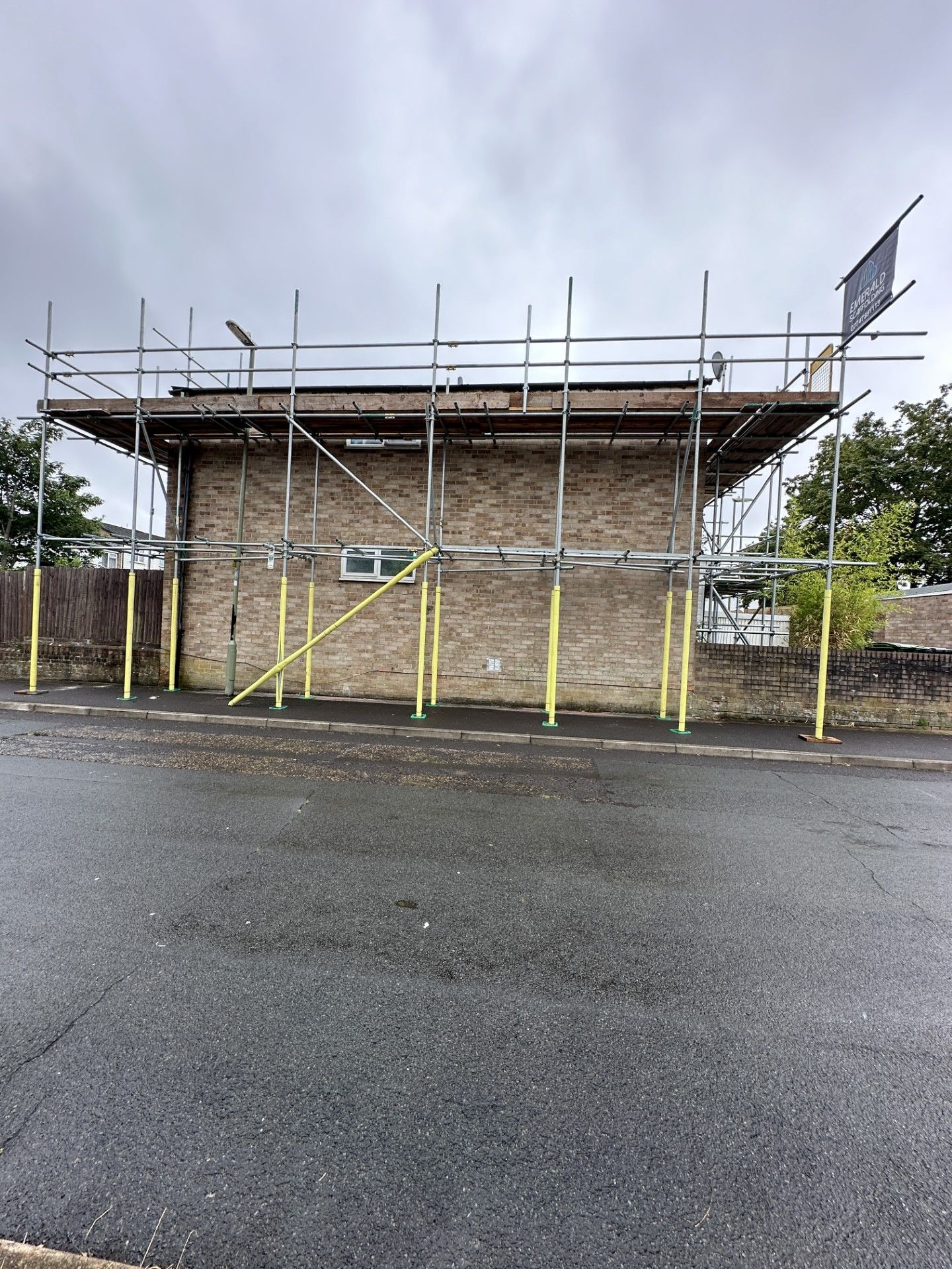 Building with scaffolding erected around it; overcast day.