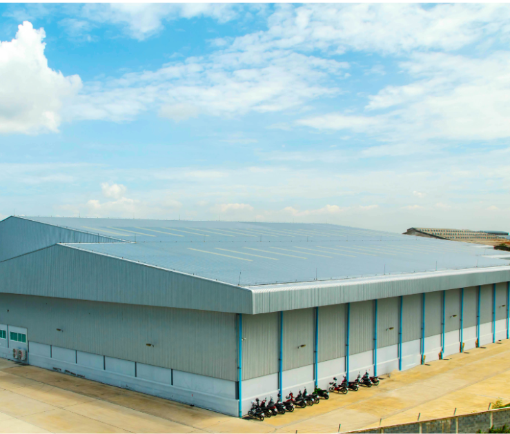 A large warehouse with motorcycles parked in front of it