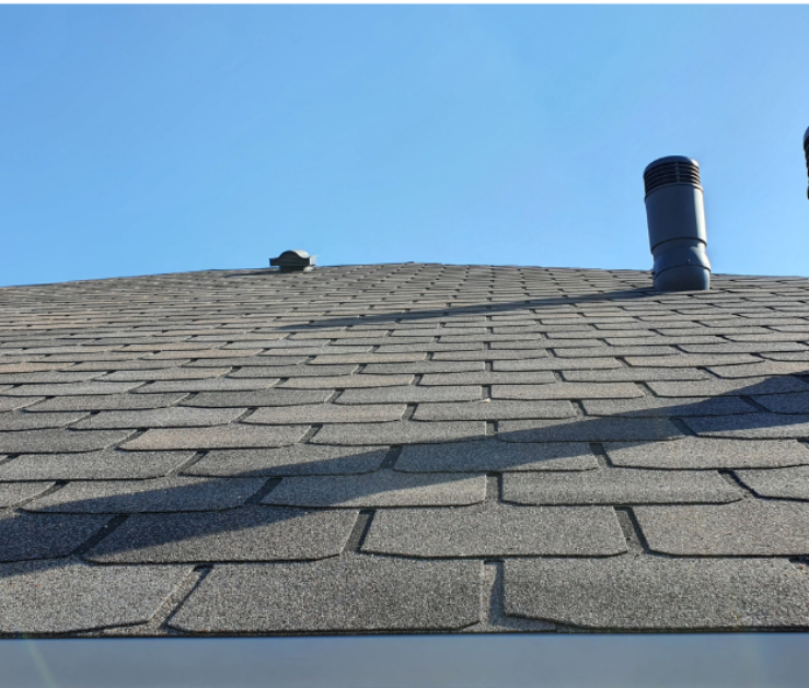 A close up of a roof with a blue sky in the background